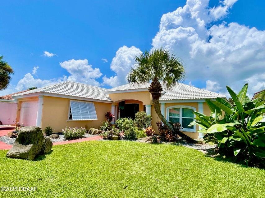 COQUINA KEY BEAUTY!!! You will love this 3 bed, 2 bath, 2 car garage home located in a tropical paradise neighborhood and only steps to the Atlantic Ocean! Beach days here are super scenic, quiet with no vehicle access, with a private community beach walkover. Lush landscaping surrounds this home with a gorgeous entry, back covered lanai, pavers, fenced yard and hurricane shutters. Inside, the kitchen features over-sized breakfast bar, a nook, and bluetooth refrigerator - with news, recipes and Pandora! Unique flooring in the kitchen is made of pennies!! The master suite has double vanities, granite, double closets and garden tub! Lots of closets, shelving and niches. Newly Tiled Roof - 2023, A/C - 2020, Water Heater - 2025 and fresh exterior paint - 2022. Updated electric panel with generator outlet. Home is not in a flood zone. Come check out this amazing home in an upscale beachside community! New owners can opt to have Spectrum cable and internet service for approx $702 per year through the HOA. Coquina Key lighting, stormwater and garbage pick-up are included in the annual tax bill.