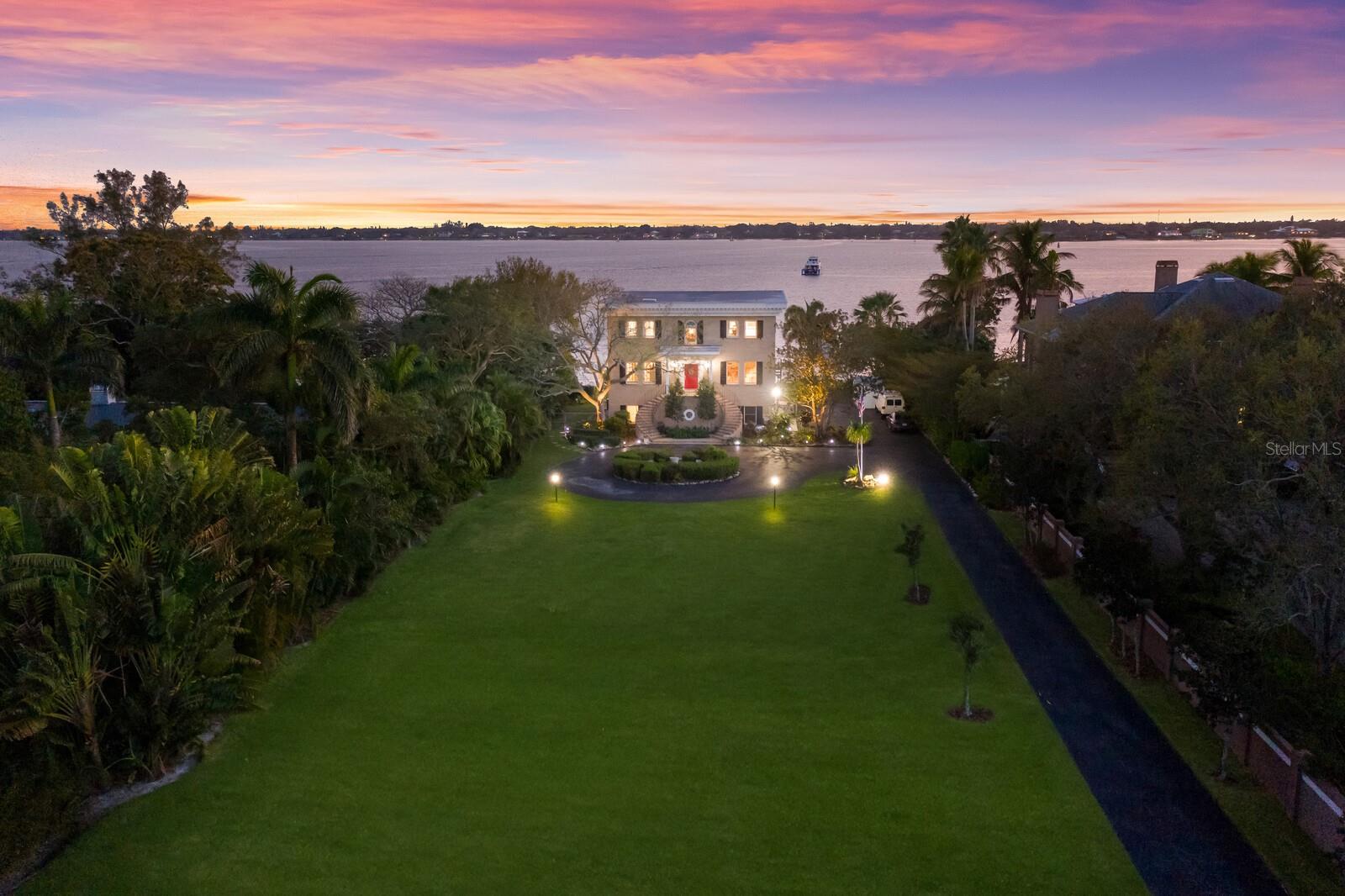 SNEAD ISLAND WATERFRONT ESTATE WITH DEEP WATER ACCESS ON 1.24 ACRES!! This spectacular property truly has the WOW factor as soon as you turn in the long stately driveway. The home is situated near the water to allow for unbelievable unobstructed views from almost every room in the house! This custom built, federal style brick home was built with privacy and water views as the focus and using the highest construction standards with brick construction with poured concrete. You will immediately appreciate the landscaped lawn, mature trees and the expansive FOUR car garage & workshop. The grand staircase leads you to this magnificent home offering over 5,400 sqft of living space. Your eyes will be drawn the the views of the river as you step in the front foyer and even the most discerning buyers will be impressed with the workmanship this home offers. The living area has high ceilings with lots of windows, crown molding throughout and a beautiful fireplace. The kitchen has been completely redone and is absolutely stunning! Featuring shaker style, soft close cabinets for all your storage needs, gorgeous quartz countertops, stainless steel appliances(with bonus wine cooler!), stylish backsplash & fixtures, prep sink with the garbage disposal, & an oversized island where you can gather with friends and enjoy that immaculate water view! Truly the type of kitchen you dream about when you scroll thru magazines! Off the kitchen you will find a Florida room with wall-to-wall windows and new LVP flooring showcasing the unreal views of the river! You will find yourself spending your evenings sitting here watching the beautiful picturesque sunsets! Upstairs you will find three bedrooms and 3 bathrooms. This home could easily be a multi generational home as there are two water facing master suites! The main master bedroom is expansive and lined with windows to capitalize on the views! The owners ensuite bathroom has been completely updated with his & her vanities,new walk in shower and multiple walk in closets. One of the closets is so large it could even make a perfect nursery. There is also an ELEVATOR that services all three floors of the home. Additionally there is a studio-sized bonus room on the first floor that offers tons of flexibility and could be used as an at-home gym, separate office or guest suite...the possibilities are truly endless! All of the high ticket items have been taken care of by the seller including new roof in 2017, septic system in 2022, 3 new air conditioners in 2020,and the hot water tanks replaced in 2017 & 2018.The backyard of this home is were the real magic takes place! You can have a white, sandy beach right in your own backyard! The 160 ft dock has recently had all the pilings replaced and offers deep water direct access. Plenty of room for just about any size boat you want to dock as well as a boatlift in place. You will have direct water access with NO BRIDGES to Tampa Bay,the Gulf of Mexico,Manatee River as well as Terra Ceia Bay,only 15 miles from the sandy beaches of Anna Maria Island & easily accessible to I-75.Located on one of the undiscovered treasures of the West Coast of Florida--Snead Island. Whether you enjoy dining or boating at the local Yacht Club,biking or kayaking all of the trails of the 365 acre Emerson State Park, or seeing the horses at the local stable, Snead Island truly has something for everyone and is old Florida living at its best!