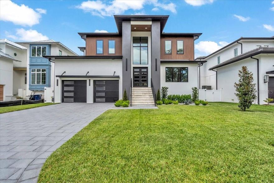 This newly completed 5,000+ sq ft Sunset Park home by Gloger Construction offers luxury and peace of mind with premium builder upgrades. Designed above FEMA standards with DOUBLE BLOCK construction and hurricane-impact windows, it features 5 bedrooms, 4 full baths, 2 half baths, a dedicated office, and a spacious upstairs bonus room. The open-concept living area includes a TEMPERATURE CONTROLLED WALK IN WINE ROOM, and a gas fireplace, flowing seamlessly to a balcony and outdoor kitchen overlooking the pool and spa. The chef’s kitchen boasts Thermador appliances, quartz counters, and a hidden butler’s pantry. A first-floor primary suite offers a spa-like bath, walk-in closet, and balcony access—all just minutes from top-rated schools and local dining.