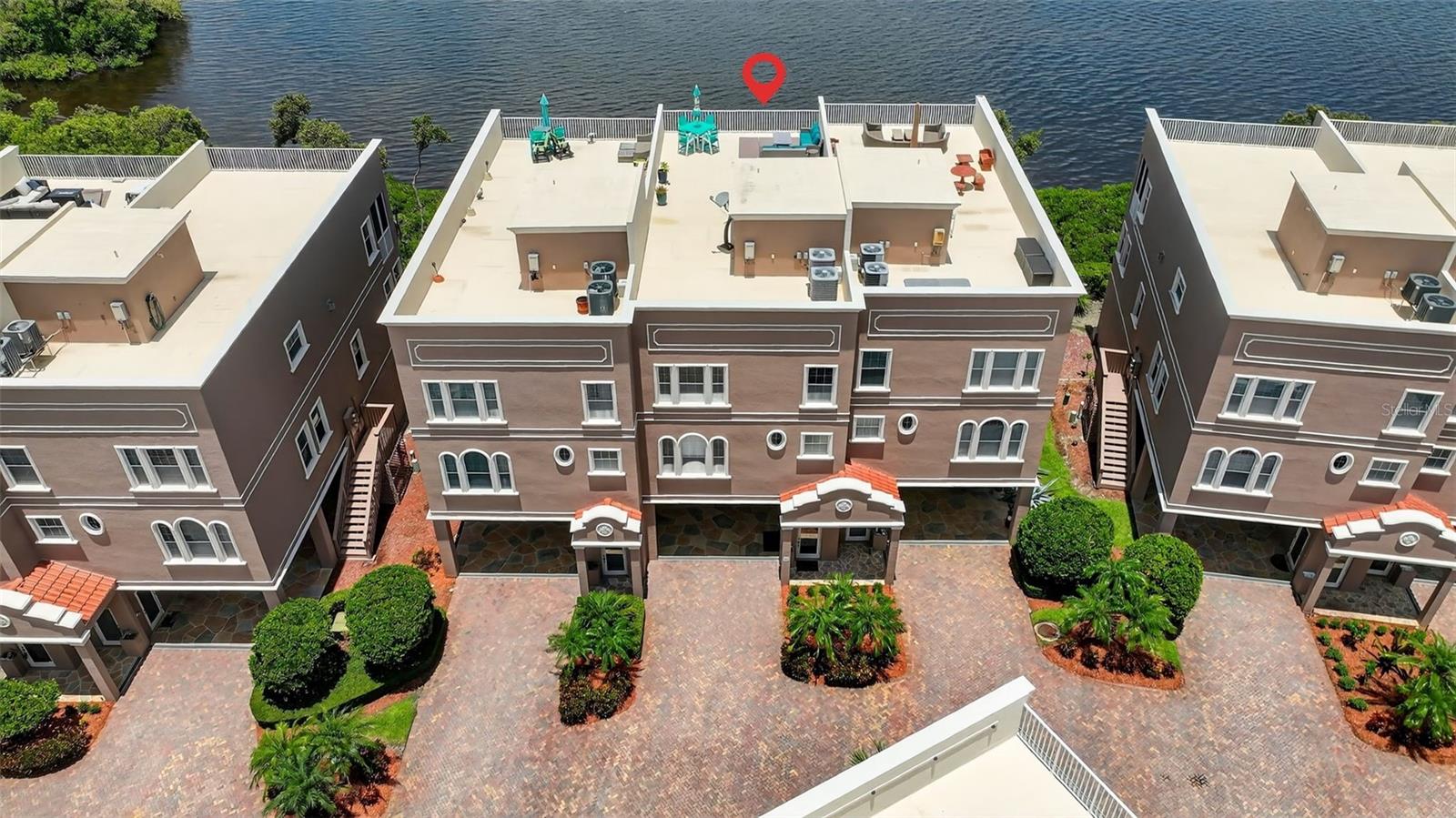 Luxurious Gulf Front Living and THE BEST VIEW Awaits in the Reserve at Mediterranean Manors here in the charming town of Dunedin. Tucked along the shores of the Gulf, this stunning four-bedroom, three-bath townhome offers unparalleled open-water views. From the moment you enter, every detail has been thoughtfully designed to capture the feeling of living on a year-round vacation. Spanning four meticulously planned levels with private elevator access to each floor, this home features a show-stopping 58x24 rooftop deck. The chef’s kitchen is a showstopper appointed with rich, custom wood cabinetry with crown molding, gleaming granite countertops, upgraded stainless steel appliances, a walk-in pantry, and a charming breakfast nook overlooking the Gulf’s open waters. The great room is the heart of the home, where nearly 10-foot ceilings, crown molding, custom built-ins, and a cozy gas fireplace frame an ever-changing backdrop of breathtaking sunsets. A flexible secondary bedroom and bonus living area on the main floor adds versatility. Upstairs, the private owner’s retreat feels like a five-star suite, complete with French doors leading to a covered, screened balcony and captivating Gulf views. Two oversized walk-in closets provide ample storage, while the spa-like ensuite bath offers maple cabinetry with granite countertops, dual vanities, a jetted Jacuzzi tub, and a custom glass walk-in shower. Two additional bedrooms on this level feature generous layouts, stylish closet systems, and access to beautifully finished baths with granite and maple cabinetry. Take the elevator to the fourth level to discover an expansive 58x24 rooftop deck, where entertaining meets unforgettable sunsets over the Gulf. Whether you’re hosting under the stars or enjoying quiet moments of reflection, this space will take your breath away. The property also includes a 2-car garage plus a 4-car carport, providing plenty of space for guests or toys. Recent upgrades include a 2019 tankless hot water heater, dual high-efficiency A/C systems, a full-home water softener and filtration system, and more. Roof replacements are included in the HOA reserves, offering peace of mind for years to come. Nestled in the highly sought-after Reserve at Mediterranean Manors, residents enjoy resort-style amenities including a heated pool, tennis, bocce, and pickleball courts, a private community beach, kayak launch, small boat mooring area, gym, and two recreational facilities. Perfectly situated just minutes from the Pinellas Trail, top-rated golf courses, award-winning beaches like Honeymoon and Caladesi Island, and the vibrant towns of Palm Harbor and Dunedin. Only 30 minutes from Tampa International Airport, this is coastal living at its most refined. It’s more than a home—it’s your private slice of paradise.