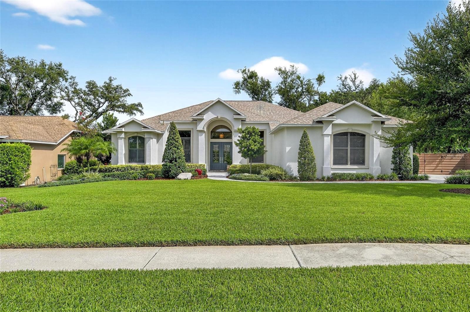 The rare combination of meticulous care and thoughtful design by the original owners has created a home with private gardens that are a must-see for potential homebuyers. Modern updates throughout the 4 Bedrooms, 3 Baths, plus an Office/Den and large Bonus Room, include the design and finishes of the kitchen, baths, fireplace, and flooring. Some of the highlights include crown molding, high ceilings, tile in the main living areas, and bamboo flooring in the bedrooms and bonus room (no carpet). The high-end finishes continue outdoors with pavers around the heated pool, covered lanai, the driveway and sidewalk, a dry bar with a TV, built-in fridge and ice maker, and an AMAZING garden and pristine landscaping that surrounds the home. The floorplan has the right mix of open living areas with the large eat-in kitchen with a gas range and large breakfast bar that overlooks the family room with a wood-burning fireplace and custom built-ins, a separate office/den for work from home, and the bedrooms on a tri-split. There are two primary suites, each in their own wing and with their own private bath and walk-in closets. The larger one is for the homeowner while the smaller one can easily accommodate long-term guests. The two secondary bedrooms share the third full bath with a large bonus room that has sliding doors to the pool area. There are two more sets of sliders to the outdoors, one from the living area and the other from the family room. With cooler weather around the corner, you’ll be able to open up to enjoy entertaining that Florida is known for. Oak Landing’s winding streets offer character, privacy, and effortless access to public and private schools (K-12), as well as shopping and dining. Thank you for your interest and for taking the time to see this exceptional property in person