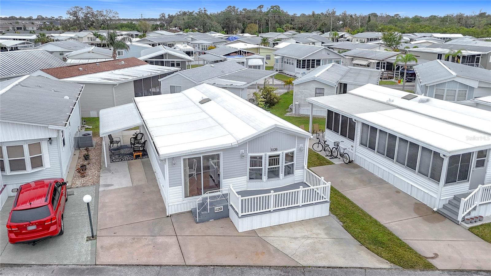 BRIGHT AND CHEERFUL MOBILE HOME IN ACTIVE 55+ COMMUNITY. One bedroom, one bathroom home sold turn-key. Enjoy the ample front deck on this welcoming home! When you enter the front of the home, there is a welcoming bonus area that could be used as dining or extra seating. Enjoy all the natural light in the eat-in kitchen and connected living room. The large family room has sliding doors that offer separation for sleeping options, and could easily become a true second bedroom. The bathroom has a Bathfitter shower and linen storage. The tilt-in vinyl windows add to the ease of maintenance. This well-kept property features a covered parking area which is currently used for outdoor seating. Room to park multiple vehicles. Shed with laundry and extra storage. Central A/C. Sold for CASH ONLY. Sugar Creek Country Club has LOW HOA FEES OF $525 PER QUARTER which include internet, cable, grass mowing, water, sewer and trash. There are 2 swimming pools, heated spa, clubhouse, tennis, pickleball, shuffleboard, a fitness room, and workshop. There is an active social calendar during the winter months. SO MUCH TO OFFER! Sorry this is not a dog lot.
