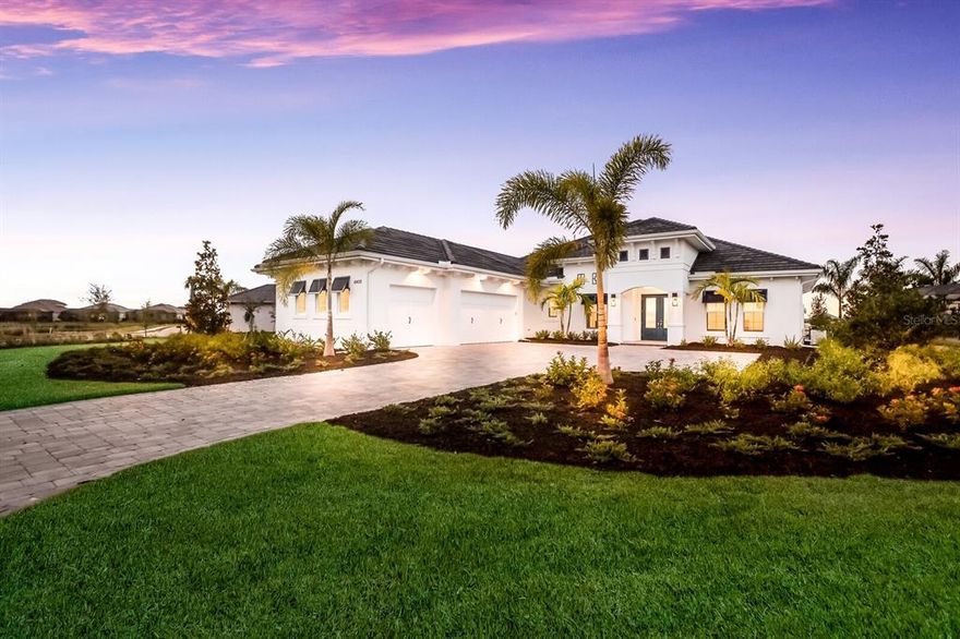 Spectacular oversized lot in The Lake Club at Lakewood Ranch, this stunning newly built 4-bedroom, 4-bath lakefront residence makes an impressive statement with a multitude of high-end upgrades and appointments, and completely designed and furnished by an interior designer including exquisite light fixtures, designer furniture, rugs, draperies, artwork and more.  The 3,754-square-foot home was thoughtfully customized by its owners, who had expected to live in it before their plans changed after it was completed. Among the upgraded features you’ll find throughout the one-level home are wood plantation shutters, beautiful tile flooring, impact windows and glass doors, cabinetry, baseboards and paint. The open floorplan is perfect for entertaining, including a large well-appointed gourmet kitchen with Jenn-Air appliances overlooking the inviting great room with faux wood tray ceilings. The kitchen also includes a KitchenAid wine cooler and wet bar, butler pantry pass-through and pantry with wood shelving. Glass sliders in the great room seamlessly transition to the expansive lanai with a panoramic screen showcasing picturesque lake views and a custom saltwater pool with swim-out benches, a 6’x6’ raised spa, and LED color-changing pool and spa lights. The lanai is perfect for gatherings of any size with large covered and open spaces for dining and entertaining, a full outdoor kitchen with a wet bar and small refrigerator, 10’ fire box and a 43” gas fireplace with surrounding tile to the ceiling. The sumptuous master suite features a double glass French door to the lanai, tile and rug, and a bathroom with dual vanities, large walk-in shower and free-standing tub. The home also includes three additional bedrooms with upgraded carpet, dining room with recessed tray ceiling, study with added built-ins and French doors, and a bonus room with a shiplap wall. Other notable highlights include a smart home system with outdoor cameras, 8 Sony TVs (one outdoor), 4 Sonos plus woofer with smart surround sound, plus a 22 KW generator. The Lake Club’s fabulous amenities include a 20,000-SF clubhouse, fitness center with state-of-the-art equipment, resort-style pool with waterfall and separate children’s pool. Don’t miss this amazing opportunity to make this exceptional move-in ready residence your own.