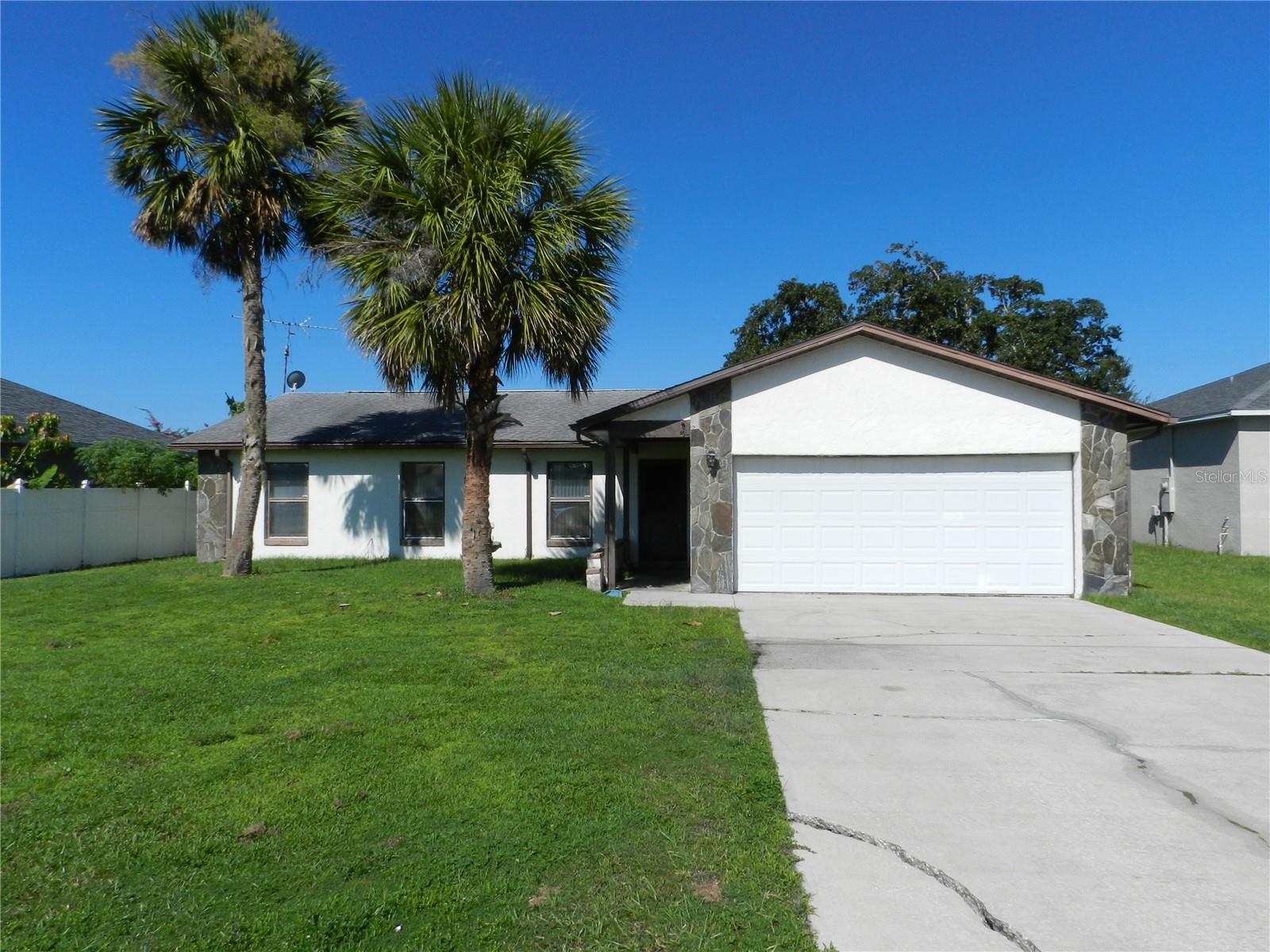 This house can become a beautiful home with some sweat equity and tender loving care. Mostly cosmetic fixer upper, has lots of potential. As you open the door a large living area welcomes you. Kitchen and dinette are directly ahead, 2nd and 3rd bedroom split to the left and primary bedroom is to the right. The 2nd bedroom has a large walk-in closet. The primary bedroom has double built in closets, a vanity w/sink and en-suite bath. Large screened back porch overlooks the back yard, which is enclosed by a wood fence. Double car garage with garage opener, has laundry area and side door to yard. A/C replaced 2017. Roof replaced 2017. Whether you are an investor, a first-time buyer, or just looking to downsize do not let this opportunity pass you.