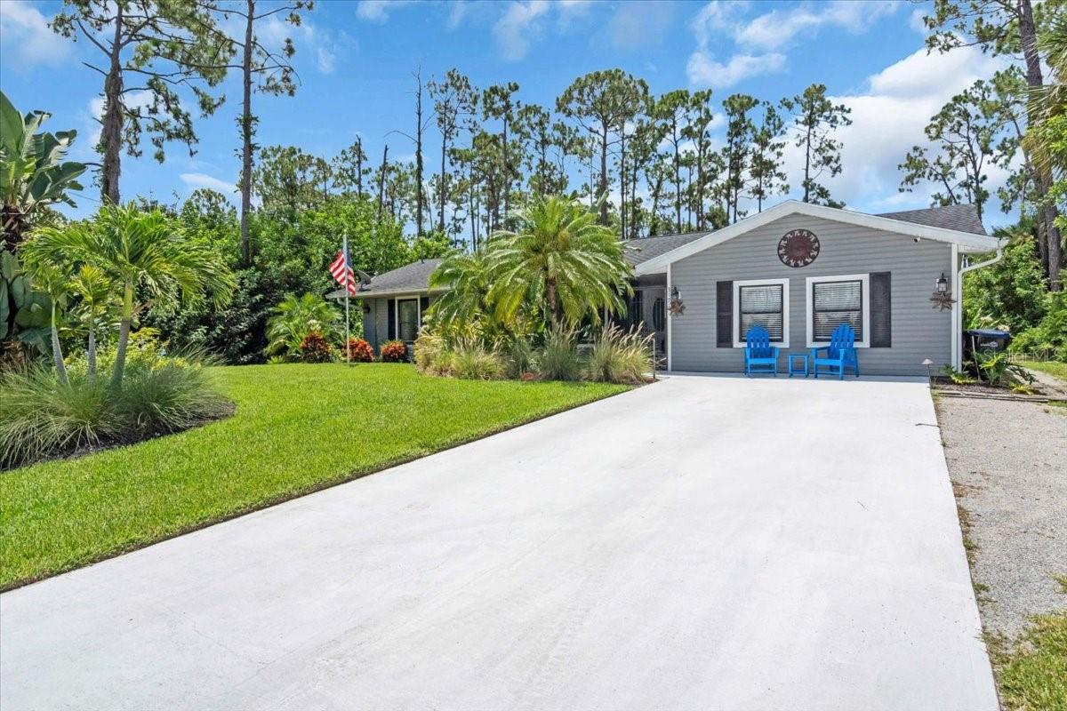 Waterfront Paradise with Saltwater Pool, Security System & Nature Views- Not in a Flood Zone! Welcome to this beautifully maintained 4 bedroom, 2 bath nestled on over ¼ acre with 80 feet of freshwater canal frontage. This nature lover’s paradise offers peace, privacy, and endless outdoor enjoyment, with a scenic deck perfect for fishing or relaxing under the shade of majestic Florida pines. Inside, the open-concept great room flows seamlessly into the dining area and kitchen, which features a breakfast bar and shaker cabinets. A spacious laundry/mud room with outdoor access provides abundant storage and functionality. Step down into the inviting Florida room that leads to a covered lanai and screened saltwater pool-complete with new pool pump and equipment, ideal for year-round enjoyment. The expansive patio includes an outdoor shower and grill, perfect for entertaining. A powered shed offers extra space for a workshop or storage. Peace of mind comes standard with a closed-circuit camera system and home security system already in place. Additional highlights include newer HVAC, water heater, appliances (all under 5 years old), updated electrical and entire house portable generator. The roof was replaced in 2018. There is also an outdoor fire pit area surrounded by lush tropical landscaping in a serene private setting. This exceptional home blends comfort, functionality, and the tranquility of waterfront living-all without being in a Flood Zone. Don’t miss your chance to own this Florida gem!