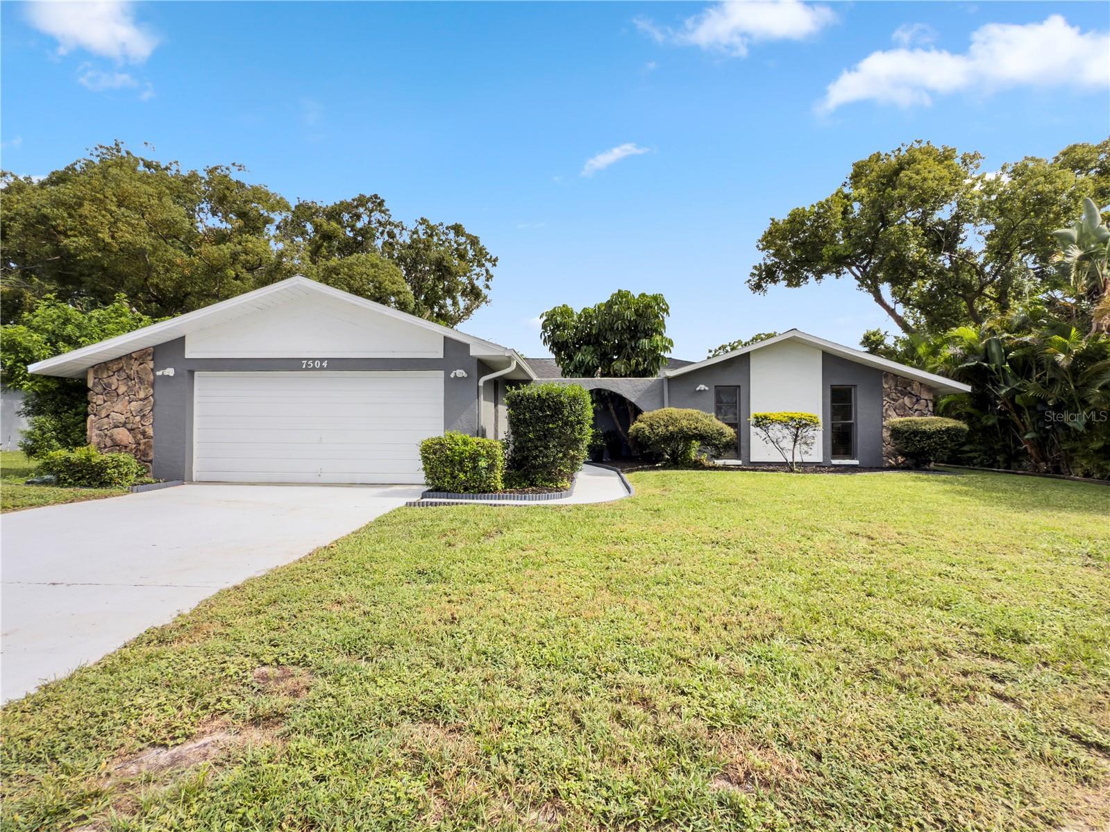 This beautifully updated, move-in-ready, 3-bedroom, 2-bath home blends timeless comfort with modern upgrades inside and out. Situated on a cul-de-sac, the grounds have been freshly landscaped. Step inside to find new paint, crown molding, and flooring. Perfect for entertaining, the home features a spacious great room with a wood-burning fireplace and adjoining den and a full wet bar. The remodeled gourmet kitchen is a showstopper with all-new appliances, solid wood cabinets with pull-out shelves, brand-new granite countertops, and a sleek tile backsplash. The light-filled primary suite offers a spacious walk-in closet and an ensuite bath with dual vanities. There are ample storage opportunities throughout, including an oversized two-car garage, three extra closets, and a dedicated laundry room. Outside you'll find a screened-in retreat complete with a jacuzzi and covered dining area - ideal for relaxing evenings or lively gatherings. Major system updates provide peace of mind: roof with new soffit, fascia, and gutters (2024), water heater (2024), HVAC (2022), electric panel (2018), and a newly insulated attic, up to R24. Best of all, this property sits high and dry - no flood insurance required. Nearby there's a community park, public library, plenty of shopping and dining, grocery stores, and an HCA Hospital. Don't miss this gorgeous home. Schedule your showing today!