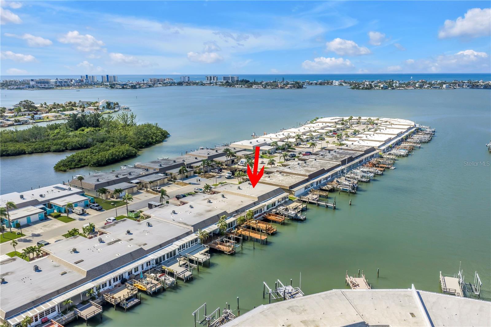 One or more photo(s) has been virtually staged. Welcome to Boca Ciega Point East, the hidden gem of 55+ waterfront living in beautiful Saint Petersburg—and now available for lease! This fully remodeled 2-bedroom, 2-bath end-unit villa offers over 1,400 sq ft of heated/cooled space, an oversized 1-car garage, and direct water access with a private boat dock.
Step inside to discover luxurious wood-tone vinyl flooring and designer finishes throughout. The open-concept kitchen is a true showstopper with custom blue wood cabinetry, quartz countertops, gold hardware, stainless steel appliances, and a seamless flow into the dining and living areas—ideal for entertaining.
Enjoy natural light from end-unit windows and glass sliders leading to both a private front patio and a spacious back deck perfect for sunsets, dolphin sightings, and fishing. The primary suite features deck access, a walk-in closet, and a beautifully upgraded en-suite bath with quartz vanity, subway-tiled walk-in shower, glass doors, and penny-tile flooring.
The second bedroom—positioned at the front of the villa—offers direct patio access, making it perfect for guests or a home office.
Live the Florida lifestyle with resort-style amenities year-round: a heated/cooled pool, tennis, pickleball, shuffleboard, and bocce courts. Plus, two beautifully renovated clubhouses: one ready for social gatherings and the second with a library, gym, and office space should be  ready by November 2025
Boca Ciega Point East is a gated, secure 55+ community that offers peace of mind, active living, and incredible water access. Whether you're seeking a seasonal retreat or long-term rental, this rare waterfront villa is your opportunity to enjoy coastal living at its best.
Schedule your showing today and make this waterfront dream your next lease!
