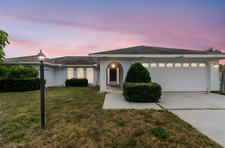 Imagine pulling into a quiet neighborhood where kids play safely on a private street ending in double cul-de-sacs. This spacious 3-bedroom retreat sits perfectly on a sprawling corner lot, offering both privacy and a premier location just three minutes from the salty breezes of Indian Rocks Beach. As you step inside, the home opens into a thoughtful floor plan where formal living and dining areas flow naturally into the heart of the home. The oversized bedrooms offer a true sense of space with abundant closet storage, while the dedicated indoor laundry room adds a level of modern convenience.
The kitchen serves as a bright morning hub with its cozy breakfast nook, looking out toward a family room anchored by a classic wood-burning fireplace—the perfect spot for cool Florida evenings. Your living space extends seamlessly outdoors to a massive birdcaged pool and deck. Here, you can spend afternoons lounging on the covered porch or splashing in the water, all while enjoying the security of a fully fenced backyard. Within walking distance of the local elementary school and surrounded by endless potential to add your personal touch, this home isn't just a place to live—it’s the coastal lifestyle you’ve been waiting for.