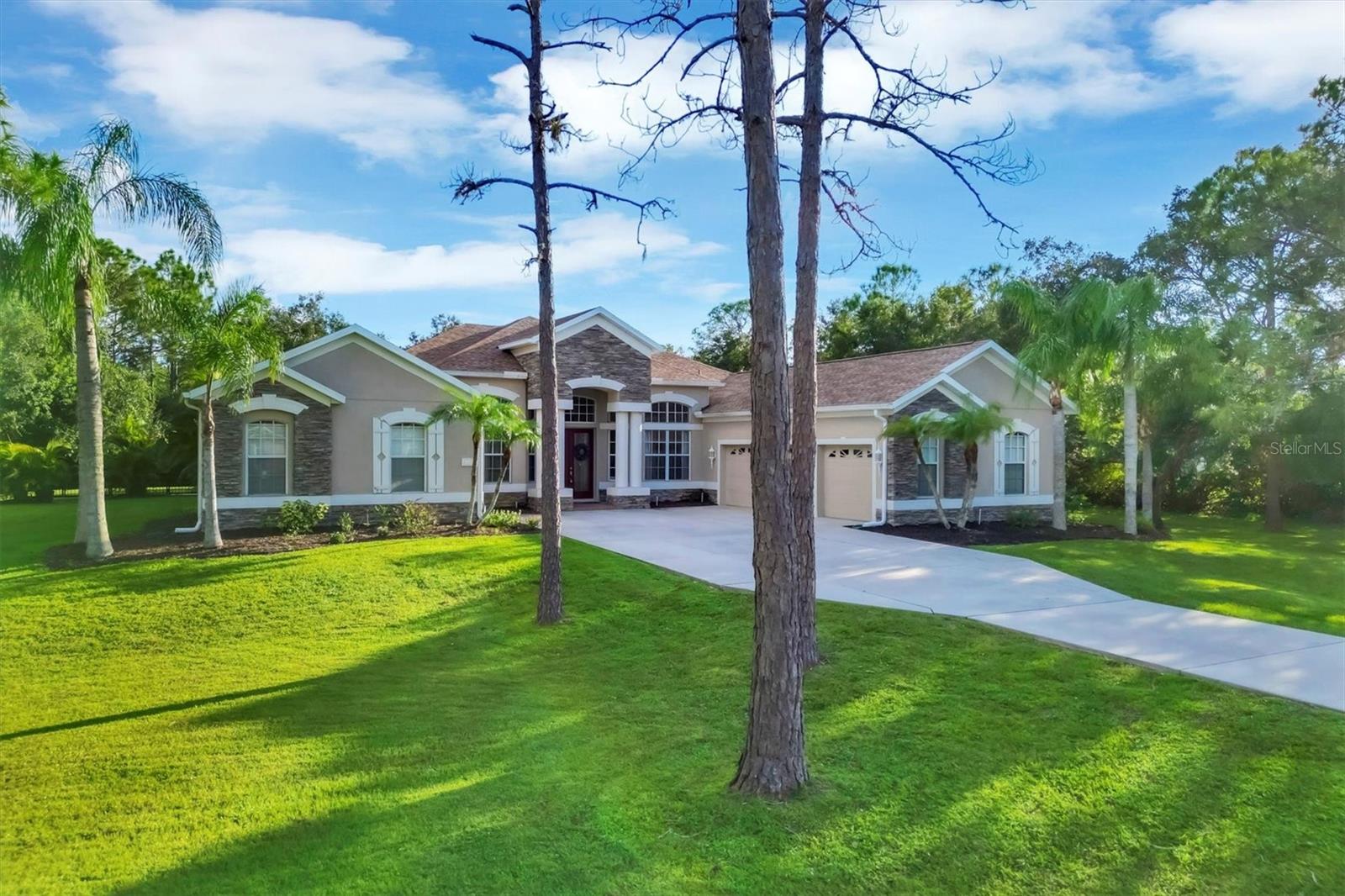 One or more photo(s) has been virtually staged. PRICED TO SELL, sellers loss$ is buyers gain! Welcome to your dream retreat in the sought after Grand Oaks at Panther Ridge! Nestled on a sprawling 1.28-acre lot adorned with majestic oaks, magnolias, and pines, this stunning, nearly 3,000 SF home offers the ultimate blend of luxury, privacy, and natural beauty. As you approach, you are greeted by an impressive entry framed by commanding double columns, stone accents and magnificent stained-glass French doors. Upon entering, you will discover an open and airy floorplan bathed in natural light, featuring high ceilings, crown molding, arched entryways, and gleaming tile floors, exuding comfort and sophistication at every turn.
The heart of this home is a chef's kitchen that will inspire your culinary creativity. Boasting ample counter space, a central island, and a breakfast bar with seating for four, it's equipped with new stainless steel appliances (2020) and a brand-new dishwasher (2022). Adjacent to the kitchen, a central living area offers seamless indoor-outdoor living with sliding glass doors leading to the backyard paradise.
The outdoor living space is a showstopper. Recently upgraded with a sparkling pool and spa with app controls, heater/cooler unit, and an extended covered patio ideal for alfresco dining. The outdoor kitchen with a Blaze grill, side burner, and granite countertops elevates your entertaining experience. Surrounded by 400 feet of aluminum fencing with dual gate access, your backyard offers both security and a private paradise for pets and play.
Additional thoughtful enhancements include a new roof (2022), luxury vinyl plank flooring in the bedrooms, Culligan whole-home water system with reverse osmosis, enhanced landscaping, Ring camera/doorbell, ADT security system, paver patio, whole home roto-rooter for pipe clean out, and converted gym space in 4th garage, bringing the total amount of upgrades and improvements to around $340,000.
Located in an "X" flood zone, this property offers peace of mind during storm seasons. Grand Oaks at Panther Ridge features low HOA fees of just $950/year with no CDD fees. Boat and EV trailer parking is allowed within HOA guidelines, perfect for outdoor enthusiasts.
Experience the perfect harmony of elegance, comfort, and natural beauty in this Grand Oaks gem, just minutes from all the amenities of Lakewood Ranch. Don't miss this opportunity to enjoy the privacy and seclusion of one of the area's most desirable communities.