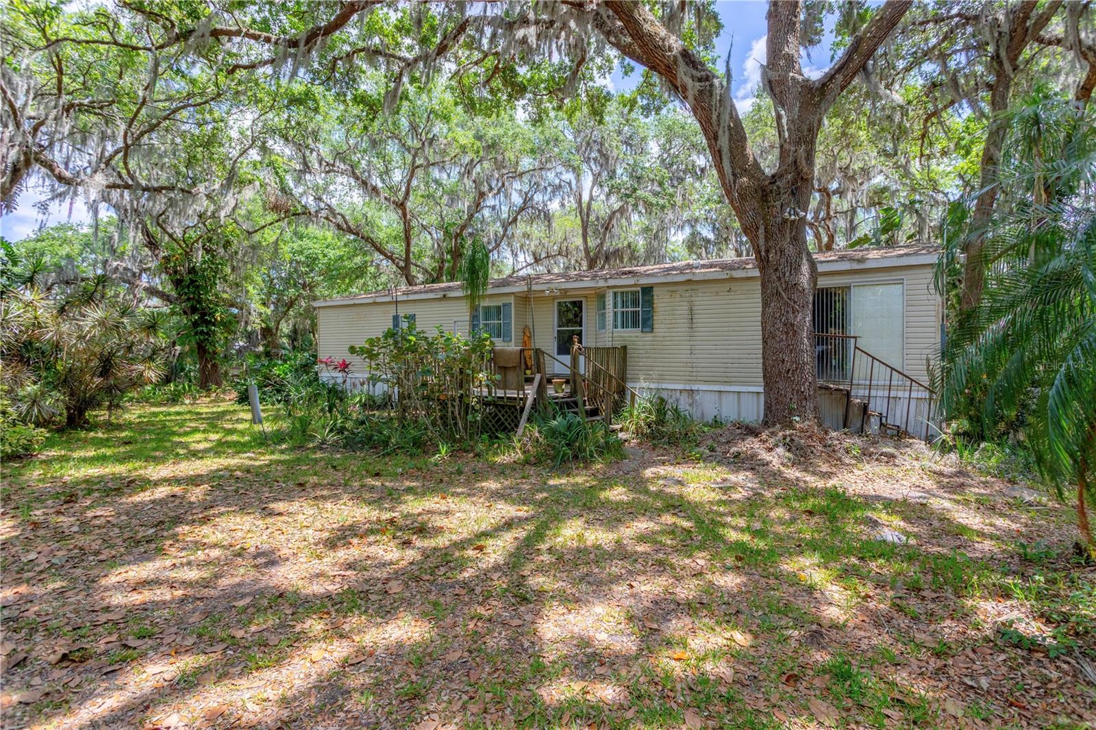 3/2 Mobile home on 5 acres. Land is a combination of wooded and cleared. Previously divided into multiple fenced areas for livestock. New roof September 2024. New AC April 2024. New Sump pump and iron-out water softener in April 2021. Perfect country living as is, or build your dream home on 5 acres.