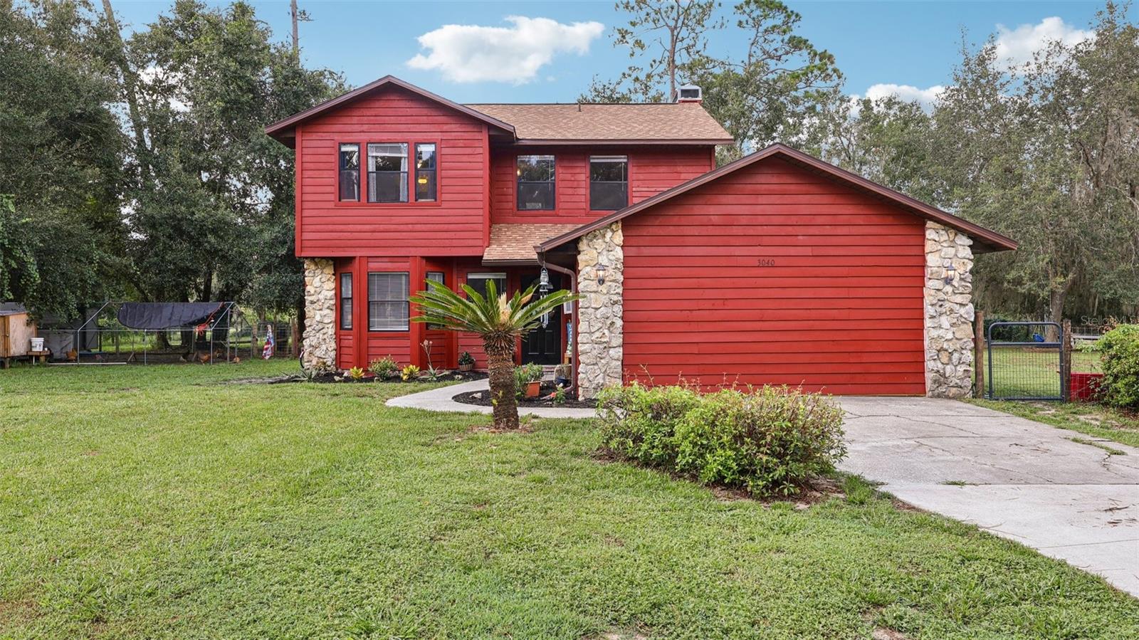 Tucked away on a sprawling 1.26-acre lot, 3040 Griffin View Dr. in Lady Lake is your chance to enjoy the freedom of space without sacrificing convenience. This inviting home welcomes you with character, comfort, and room to live life your way. Inside, you'll find 3 cozy bedrooms, plus a thoughtfully finished garage that adds versatile bonus space—perfect for a playroom, craft studio, guest retreat, or whatever your heart desires. (Please note: these additional rooms are not permitted as bedrooms.)
The heart of the home features brand-new flooring downstairs and a gorgeous rock fireplace that sets the tone for relaxed evenings and warm gatherings. The kitchen is equipped with newer appliances, making daily life just a little easier. The roof? Less than a year old—one less thing to worry about!
Step outside and take in the serenity of your private acreage. Whether you're dreaming of raising chickens, starting a garden, or simply enjoying morning coffee while the sun rises over your slice of Central Florida, this property gives you the space and flexibility to make it happen. Located just minutes from all the action in The Villages, yet peacefully tucked away, this home is truly the best of both worlds. Come see how perfectly it fits your lifestyle!