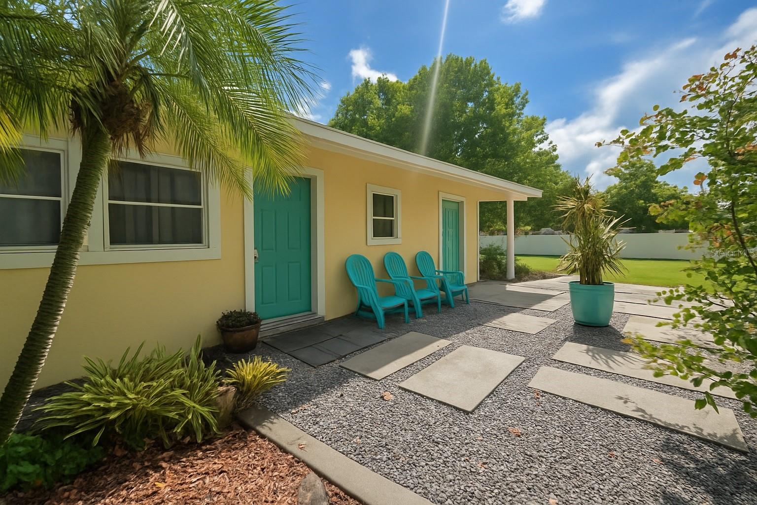 Welcome to your Florida home oasis. You can find your oasis arriving from any area, close to major roads and highways. Minutes to local shops and eateries. Your end of property sits on a half an acre lined with beautiful trees and as you turn into the stone driveway you have plenty of parking. Whether you park 4 oversized trucks or 6 cars there's also overflow for gatherings. The lawn across the way is owned by the county so nothing will be built in front of the neighbors fence. Great with no HOA. The natural landscaping will have you truly coming home to a peaceful sanctuary. The front has a covered porch to watch for those packages to arrive and watch the butterflies fly on those summer sunset evenings. As you enter the all tile home you are greeted with an open space to make yours. The bedrooms and bath are all located to the left of the living room. The inside laundry room won't have you forgetting about those clothes. The tankless water heater is on propane to keep costs low. As you enter the kitchen to make homemade meals on a propane stove and oven. The countertops are made from quartzite. The quartzite offers a natural stone aesthetic with high heat resistance so you don’t have to worry about where to put those learning to cook meals to cool down. Off the kitchen leads you to the sunroom before going outside. Once you step outside you may spend all your time in the sand. That’s right, a custom sandy backyard for your own beach paradise. You have two covered areas to enjoy the shade and keep you from those rainy days as you read a book. There is a large custom powered workshop to keep your creative crafts flowing or great for storage, you can even make it into a she-shed and hang out or have space for independent living. The property is fenced so you have plenty of private space. This is a must see home to call yours.