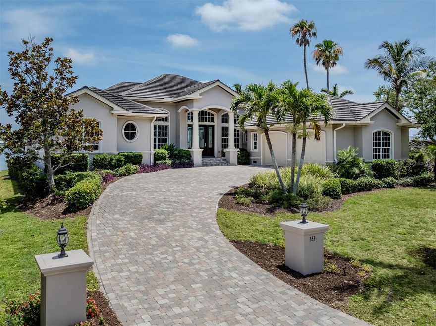 One or more photo(s) has been virtually staged. Waterfront elegance in Nokomis with sweeping bay views. Experience coastal luxury in this beautifully appointed Nokomis waterfront residence, ideally elevated and equipped with impact windows for peace of mind and panoramic views. This three-bedroom, three-and-a-half-bath home is a boater’s paradise, directly on Roberts Bay offering Gulf access via the Venice inlet and a large dock equipped with water and electricity. Inside, discover refined craftsmanship throughout with rich, brand new, wood flooring that flows seamlessly throughout the entire home. Soaring ceilings accented by designer double-tray ceilings with ambient lighting add a touch of sophistication to the expansive great room and both primary suites. Each of the dual primary retreats offers breathtaking bay views, spa-like baths and oversized walk-in closets. The gourmet kitchen is a chef’s dream fully equipped with luxury appliances that you would expect in this caliber of a home. It also boasts exquisite wood cabinetry with glass accents and pullout drawers, ample granite countertops, a spacious island and additional breakfast bar. Adjacent dining space invites intimate meals or entertaining on a grand scale. A wall of French doors opens the great room to the outdoor oasis offering an infinity-edge pool and summer kitchen framed by pavers and endless turquoise water views, all positioned with desirable southern exposure. Additional highlights include a generous inside utility room with abundant storage, hurricane-impact windows, and an oversized two-car garage with space for a workshop and golf cart. Live the waterfront lifestyle with style, comfort and unending views.