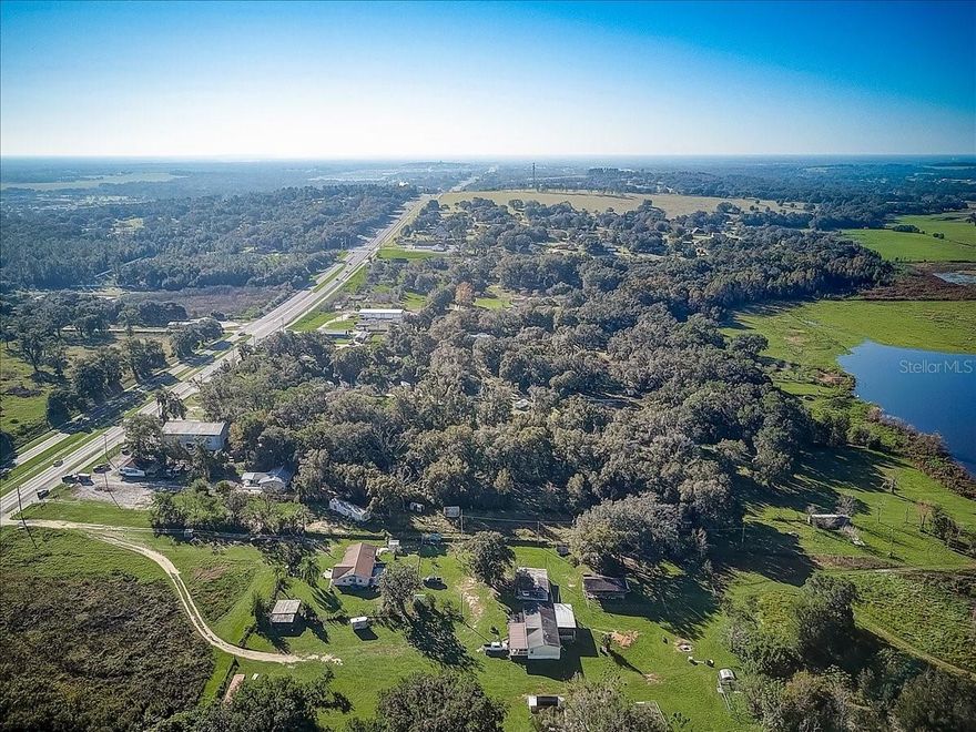 Terrific opportunity for the creative Buyer! 4.75 acres in Dade City adjacent to both U.S. Highway 301 and Lake Gilbert. The front portion of the property is approximately an acre in size and zoned commercial with 166 feet of frontage on U.S. 301. It contains an 84 by 73 foot concrete slab approx. 6000 square feet, that can accommodate a variety of future uses. The remaining approximately 3.75 acres is zoned multi-family and abuts Lake Gilbert. It contains a 2 bedroom, 1 bath, concrete block home. You must see this property to appreciate its potential!