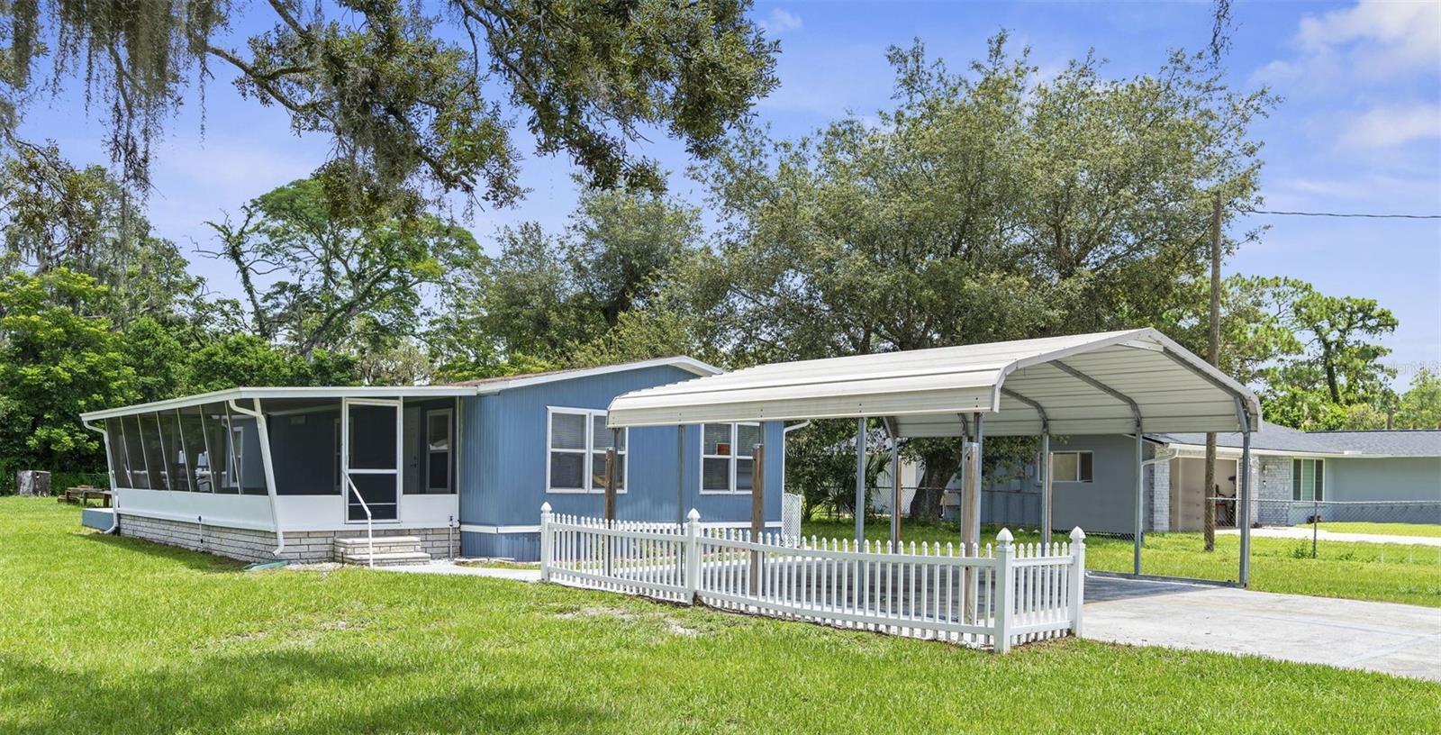 Fully Remodeled Pool Home with New Windows & Modern Upgrades in Parkwood Acres! Welcome to this beautifully remodeled 2-bedroom, 2-bathroom pool home nestled in the heart of Parkwood Acres! This move-in-ready property features brand-new laminate flooring in the main living areas and soft new carpet in both bedrooms. Enjoy peace of mind with newly installed energy-efficient windows that bring in natural light while helping keep energy bills low. The updated kitchen boasts stunning Corian countertops, custom wood cabinets, and brand-new stainless steel appliances—including oven/range, microwave, refrigerator, and dishwasher. Both bathrooms have been tastefully renovated with stylish, modern finishes. Step outside to your oversized front porch, perfect for relaxing or entertaining, and take a dip in the private above-ground pool. The fully fenced yard includes multiple sheds with electric—ideal for storage, a workshop, or hobbies—and a two-car carport offers ample parking. With no HOA and convenient access to shopping, dining, and the Suncoast Parkway, this home is a rare find. Schedule your private showing today before it’s gone!