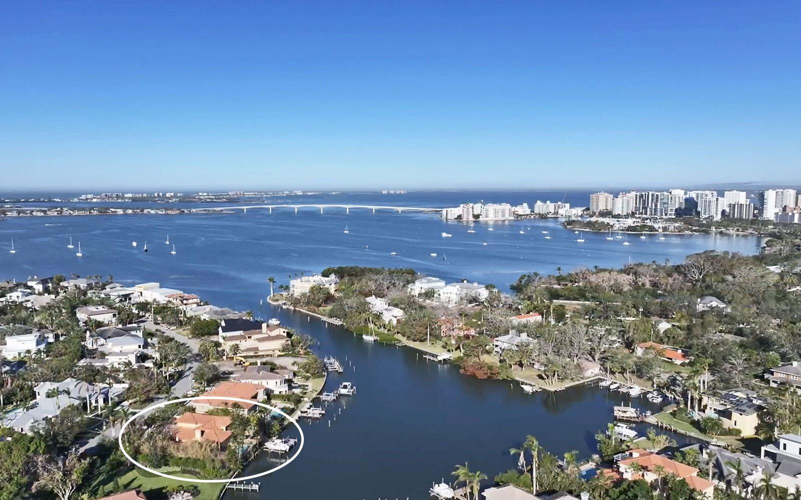 Harbor Acres one-third-acre waterfront property on the widest part of the neighborhood's deep-water harbor on Sarasota Bay. The views are spectacular! Photos 3, 4 and 5 show the views from 18, 35 and 41 feet which correspond to the views from a home built on this property. Boaters will love the location on a protected, sailboat water basin with no bridges to the Gulf of Mexico. Newer boat dock and boat lifts accommodate up to 15,000-pound boat plust two recreational water craft, making access to Sarasota's waterways and the gulf super easy. Of all Sarasota’s great neighborhoods, Harbor Acres is considered one of the best — best location, best waterfront, best appreciation, best pedigree, best neighbors. Residents love being part of the close-knit community & being so close to Downtown Sarasota and in-town amenities. The convenient, in-town location is just half a mile from Sarasota Memorial Hospital and Southside Village, one mile from downtown Sarasota, and four miles from St. Armands Circle and Lido Beach. This property is being sold as is at land value, as the home experienced flood damage. Get your building team together to create the home of your dreams in Harbor Acres — the perfect address for your Sarasota luxury lifestyle.