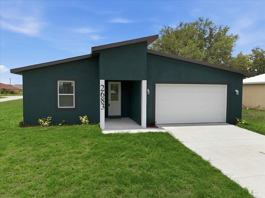 One or more photo(s) has been virtually staged. From the moment you step through the impact-rated front door into soaring 10-foot ceilings and 8-foot interior doors, this 3-bedroom, 2-bath home with a den feels immediately spacious and intentional. Rich ceramic tile plank runs throughout, complemented by 5¼" baseboards and recessed lighting that give every room a finished, custom feel. The kitchen delivers where it counts, quartz countertops, soft-close wood cabinets with dovetail construction, and stainless steel appliances make it as functional as it is beautiful. The generously oversized primary suite well beyond the standard bedroom footprint offers a walk-in closet and a private en-suite with dual sinks and a tiled shower. All bedrooms and the living room are outfitted with ceiling fans and fitted blinds. Impact windows, sliders, and doors provide year-round peace of mind. Unwind on the covered lanai or relax on the welcoming front porch, comfort lives here, inside and out. The oversized 2-car garage with a convenient side entry door completes the package.