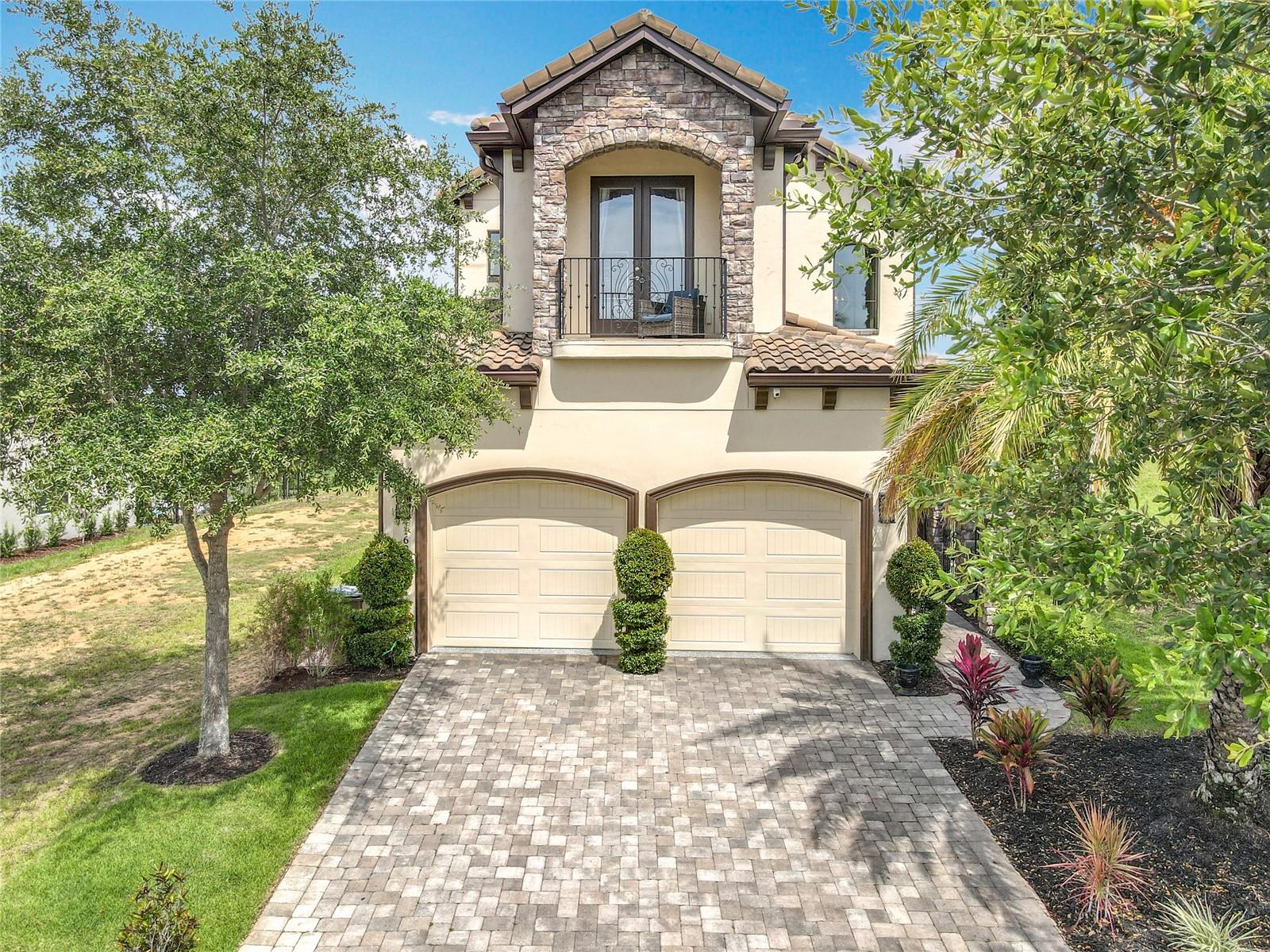 This is an exceptional opportunity to own a modern masterpiece inspired by the spirit of Tuscany. “Vista Chiaro,” crafted by Vogel Building Group, is nestled within Central Florida’s premier private community, Bella Collina.From the moment you enter, you're welcomed by soaring ceilings, solid core doors, and natural light pouring over sleek architectural lines, designer fixtures, and polished tile flooring.The home offers dual oversized master suites—one on each level—perfect for multigenerational living or guest privacy. Both feature spa-like baths, generous closets, and access to laundry rooms on each floor.The gourmet kitchen is appointed with high-end cabinetry, granite counters, and statement lighting, while a custom under-stair wine bar adds style and function for entertaining.Upstairs, a cozy loft lounge overlooks the main living space, offering a retreat for relaxing or informal gatherings.Step outside to your private oasis featuring a sparkling pool, summer kitchen, lush landscaping, and a motorized screened lanai for seamless indoor-outdoor comfort. Enjoy sunrises and Disney fireworks from your second-floor balcony overlooking the 9th fairway of the Nick Faldo–designed golf course. Just a short walk away, the Bella Collina Clubhouse offers dining, spa, tennis, fitness, and a world-class country club experience.