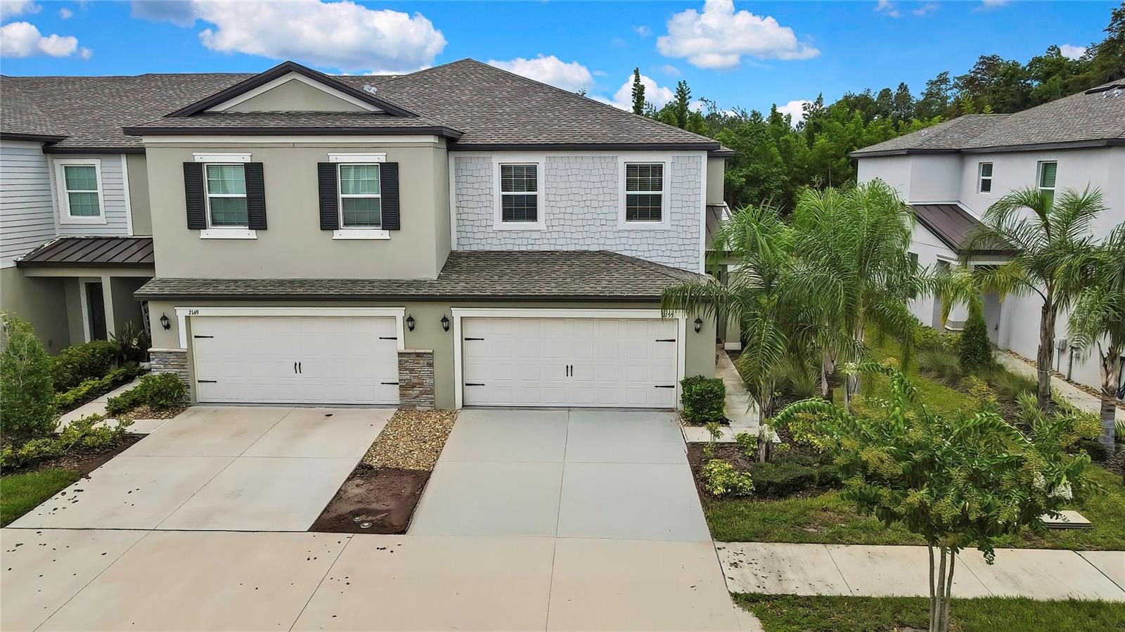Experience the Low-Maintenance lifestyle with this captivating, East facing townhome built in 2022—Water/Sewer included and NO CDD fees! Nestled within the Cypress Ranch community in Lutz, this luxurious residence offers comfort, space, and convenience. Boasting three bedrooms, two and a half baths, and a 2-car garage, this two-story townhome spans an impressive 1,801 sq ft. Its open-concept layout seamlessly connects the family room, dining area, and kitchen, all featuring elegant 18" diagonal tile flooring on the first floor. Ascending the carpeted staircase, you'll find a versatile loft area, two secondary bedrooms, and a tastefully appointed bathroom with a vanity, granite countertop, and tiled tub shower. These bedrooms are positioned at the rear of the home overlooking a tranquil conservation area. Toward the front of the home, the spacious primary suite serves as a private retreat, offering ample room for a sitting area, crown molding, a capacious walk-in closet, and an ensuite bathroom that is sure to delight. The ensuite bath boasts a relaxing soaking tub, a separate shower, a double vanity with granite counters and undermount sinks, and a private water closet. The landscaped front yard complete with palm trees and a pathway framed by greenery, leads to the private side entrance. Inside, crown molding enhances the foyer, which elegantly extends throughout the family room, dining area, and kitchen. In the hallway toward the garage off the kitchen is a convenient half bathroom with a pedestal sink, and a substantial storage closet is tucked beneath the staircase. The kitchen is a culinary enthusiast's dream, featuring gleaming granite countertops, 42" wood cabinetry embellished with crown molding, stainless steel appliances, a breakfast bar with pendant lighting perfect for casual dining, and a pantry. Sliding glass doors from the dining area to the screen-enclosed lanai and the spacious backyard, bordered by a vinyl fence across the back at the property line and a wooded area beyond. Located in a highly sought-after school zone, this home falls within the brand-new Skybrooke K-8, opening August 2025. Skybrooke will serve Kindergarten through 8th grade and feature exciting academic focus areas such as Aerospace/Robotics, Computer Science, and Medical Skills, along with traditional middle school sports including volleyball, cheerleading, soccer, football, basketball, track, and field. This prime location also provides easy access to major highways, Tampa Premium Outlets, Tampa International Airport, top-rated restaurants, hospitals, and all the attractions that Tampa Bay offers. Your peace of mind is ensured with the inclusion of hurricane shutters. Don't let this exceptional opportunity slip through your fingers! Schedule your showing today!