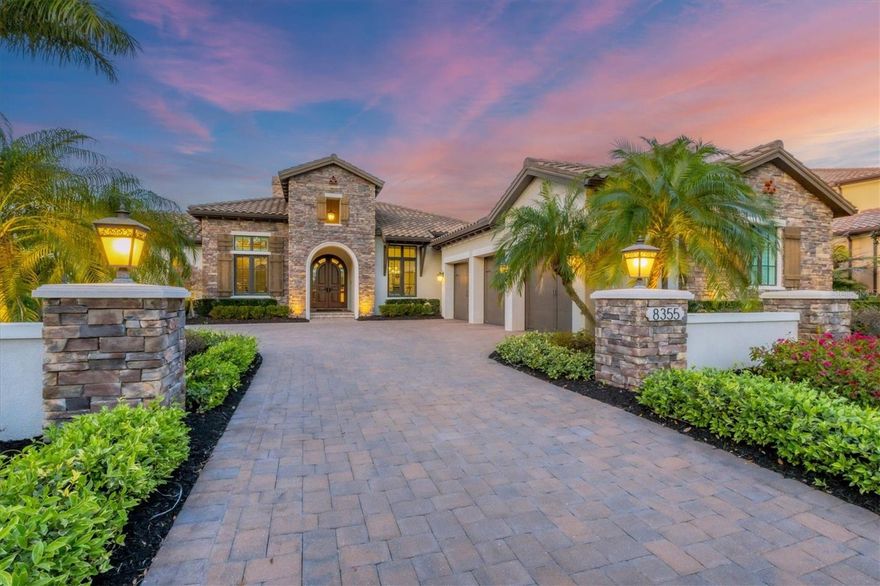 Refined, luxurious living is within reach in The Lake Club at Lakewood Ranch!  This 2016 custom-built Arthur Rutenberg home graces over 100 feet of lake front views with impressive upgrades and detail that are sure to please the most discerning of buyers.  Featuring high-quality construction and carefully selected upgrades, this true 3 bedroom and 3-bathroom home showcases modern living amidst a peaceful lakeside setting.  The stacked stone façade and Florida landscaping invite you home along the paver driveway and column-entry, setting this residence apart from its neighbors.  The arched entryway and custom solid wood door with glass arched surround showcase the first custom elements that are present throughout this home.  From the moment you enter, you will be impressed with immediate lake views, rich hardwood flooring, custom ceiling and wall details, all in a warm neutral color palette.  The grand great room sets the tone for comfortable living and elegant entertaining with a cozy gas fireplace, coffered ceiling, and 10’ impact, sliding glass doors to the lanai with sweeping lake views.  The elegant kitchen is sure to impressive chefs and guests alike with resplendent upgrades including a central island with seating, a custom dry bar with display cabinetry and two 100+ bottle Sub-Zero wine refrigerators, hidden walk-in pantry, Dacor dual fuel range, granite counters, custom range hood, and more. Whether the occasion calls for upscale dinners or casual weeknight get-togethers, this home has space for both with a formal dining room or a casual dinette with corner sliders. Or take your entertaining outdoors, with a seamless flow this residence allows you to enjoy the best of Florida living every day.  The spacious paver lanai offers space for gathering around on the fireplace on cozy evenings, or eating alfresco by the outdoor kitchen with stainless steel grill, or basking in the sunshine in the custom heated freeform saltwater pool and spa – all while taking in relaxing views of the lake through the colonnade screen enclosure.  Indoors there is room for both work and play with a stately study with glass French doors and built-ins along with the rear bonus room with large windows and sliding glass doors to the lanai.  The primary suite is your private escape with lake views from the moment you wake up through large clear windows over the seating area and, also includes dual walk-in closets with custom shelving. The primary bathroom is unparalleled with thoughtful upgrades and impressive finishes including dual, split vanities, makeup area, freestanding modern spa bathtub, and walk-in shower with frameless glass enclosure and rain shower head. Guests will enjoy their own respite in two guest bedrooms (both large enough for king beds) with two full guest bathrooms, and separate entrances for privacy.  Complementing this impressive residence is a large laundry with plentiful storage cabinetry, and a side-loading 3-car garage. Aside from the exquisite finishes, this home also has practical upgrades in the full impact windows and doors throughout, Control4 system with speakers in the great room and lanai, and 2023 tankless water heater. The Lake Club is a private gated community including a grande clubhouse, restaurant, pool, tennis, pickleball, playground, basketball, Linear Park, fitness center, dog park and interlinking lakes for kayaking or fishing. Lakewood Ranch is close to shopping, dining, A-rated schools, parks, and nearby beaches.