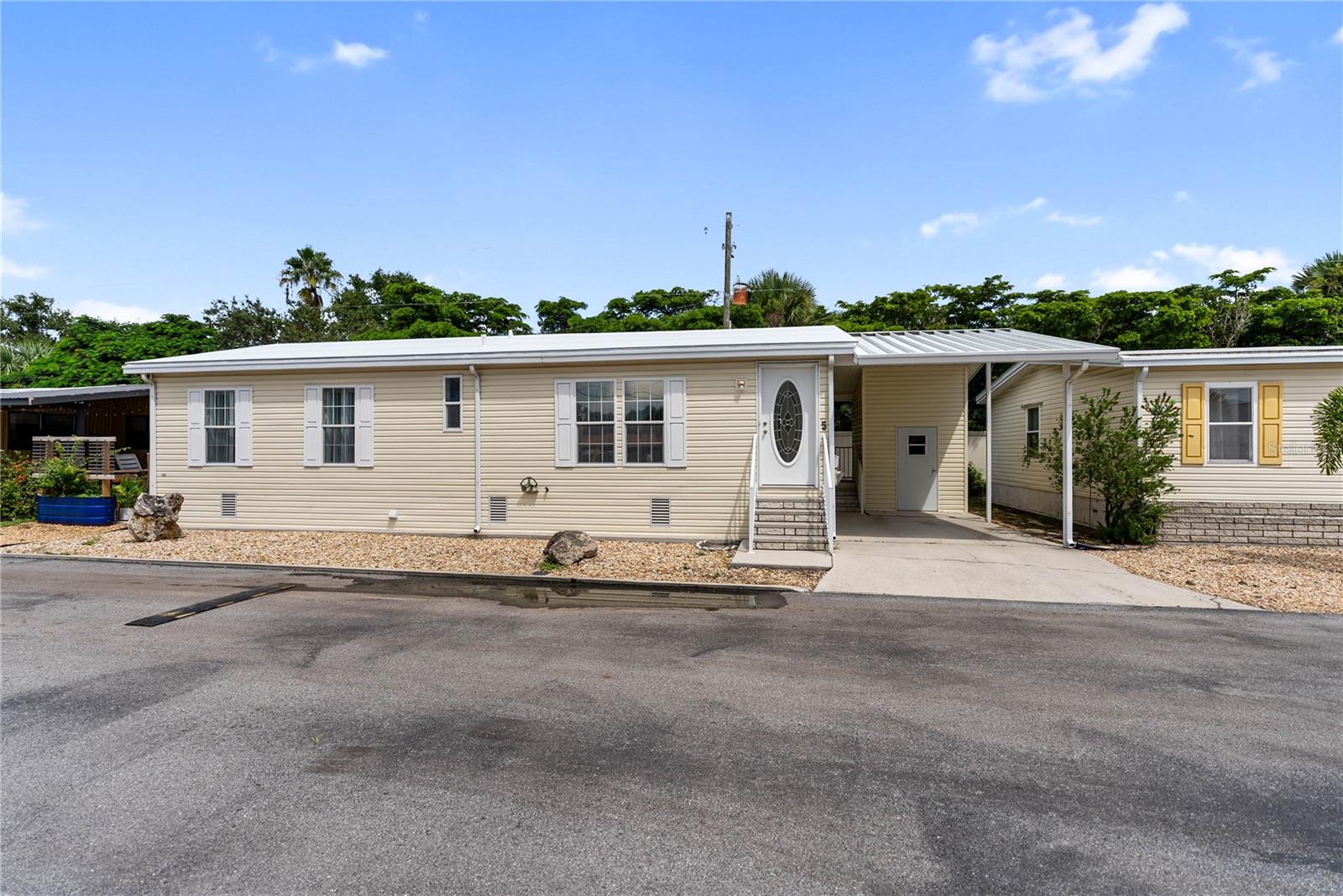 Step into coastal living at its best with this charming 2-bedroom, 2-bath double-wide manufactured home located in the sought-after South Winds Mobile Home Park Co-Op. Built in 2005 and thoughtfully updated, this residence blends comfort, convenience, and community in a prime Sarasota location.
Inside, you’ll find a bright open floor plan featuring a spacious great room, a kitchen with center island and breakfast bar, and a cozy dining area—perfect for everyday living or entertaining guests. The split-bedroom design ensures privacy, while the interior laundry closet with washer and dryer makes chores a breeze.
This home has been well maintained with major upgrades, including a brand-new membrane roof, a new heat pump system, and a new air conditioner installed in August 2025. A covered carport and storage shed provide extra functionality and room for your beach gear, bikes, or tools.
Enjoy a low-maintenance lifestyle with a monthly co-op fee of just $195, which covers cable, water, sewer, lawn care, and access to the community’s amenities. Relax in the heated pool, connect with friendly neighbors, and take advantage of the ideal South Sarasota location—just minutes from Siesta Key Beach, shopping, dining, and downtown Sarasota.