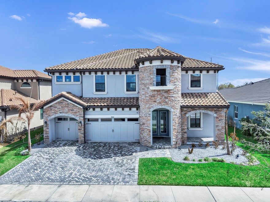 Welcome to LUXURY living in the GATED enclave of Hawkstone Artisan, where executive-style homes built by WestBay are thoughtfully crafted on OVERSIZED HOMESITES. This stunning Verona floor plan with European Country elevation offers over 3,500 square feet, 5 bedrooms, 4 baths, a backyard oasis and POOL, and a 3-car garage with a built-in Tesla EV charger.  Step inside this beautifully designed two-story open concept home where a welcoming foyer leads to a private den/study, ideal for working from home or creating a quiet retreat.  The expansive grand room, features DRAMATIC SIX-PANEL GLASS SLIDERS that flood the space with natural light and seamlessly connect indoor and outdoor living.  The adjoining casual dining area and gourmet island kitchen create the perfect setting for entertaining and everyday living.  The chef’s kitchen showcases white cabinetry, Calacatta QUARTZ countertops, stainless steel appliances, a designer backsplash, corner pantry, and an extended center island perfect for gathering with family and friends.  A convenient FIRST-FLOOR GUEST SUITE with full bath provides privacy and flexibility for visitors or multigenerational living.  Upstairs, you’ll find an expansive bonus room, ideal for a media space, game room, or additional lounge area.  The private owner’s retreat offers a peaceful escape featuring a large bedroom with an ensuite including separate his and hers vanities, a standalone soaking tub, oversized walk-in shower with a rainfall shower head, private commode and massive walk-in closet with a custom organization system.  The oversized secondary bedrooms each feature generous walk-in closets, providing comfort and storage for everyone.  However, the highlight of the home is the BACKYARD OASIS! Enjoy a large private swimming pool, screened lanai, and an extra-large paver patio perfect for relaxing or hosting gatherings.  The oversized yard backs to beautiful CONSERVATION VIEWS with NO REAR NEIGHBORS, offering exceptional privacy and a tranquil natural setting.  This remarkable home combines luxury design, spacious living, and resort-style outdoor amenities in one of the area’s most desirable gated communities.  Zoned for top-rated schools, including Newsome High School, this home offers everything you can want, and more!