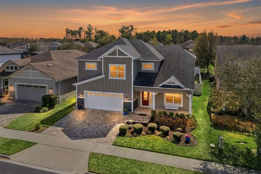 One or more photo(s) has been virtually staged. Welcome to a home where modern farmhouse charm meets thoughtful design—delivering the custom-home experience without the wait or expense, showcasing finish quality typically reserved for homes at significantly higher price points. This stunning 5-bedroom, 4-bath residence occupies one of the most coveted lots within gated Crown Point Preserve, with frontage opening to 4 acres of pristine HOA common area featuring manicured green space, picnic areas, and playground—eliminating the traditional "looking-at-your-neighbor" feel while offering park-like views from your front windows. Privacy along a picturesque, low-density street, yet minutes from 429 and historic Plant Street in Winter Garden. Freshly painted modern farmhouse exterior features premium Mattamy finishes, owner-expanded paver driveway accommodating three vehicles side-by-side, covered front porch, and beautifully landscaped yard that invites you to appreciate the quality before stepping inside. Inside, executive presence created by 8ft ext doors, gorgeous tile flooring throughout the entire main level, custom window trim, and elevated attention to detail in every corner. Flexible entry space for home office or elegant living. Gourmet kitchen commands attention with oversized island, apron-front stainless sink, abundant pot drawers, 42-inch upper cabinets with crown molding, quartz countertops, premium stainless package, glass tile backsplash, and expansive walk-in pantry—every detail speaks semi-custom finish. Open-concept living flows effortlessly to spacious screen-enclosed lanai with extended paver entertaining space via 8-foot triple slider, dissolving the barrier between indoor and outdoor. Trio of windows floods space with natural light throughout the day. Beautifully landscaped, tree-shaded backyard offers ample room for pool, fully-fenced for privacy, and the lanai with extended pavers provides exceptional year-round entertaining. First-floor bedroom with full bath provides flexibility as guest quarters or office. Three-car tandem garage features 9.5-foot ceilings. Upstairs showcases beautiful hand-scraped hardwood flooring, with a versatile family loft enhanced by recessed lighting creating perfect game room or teen lounge. Primary suite spans rear with spa-inspired bath featuring walk-in shower, dual vanity with stone top, large linen closet, and oversized walk-in closet. Bedroom three oversized with walk-in closet, shares Jack-and-Jill bath with bedroom four (also walk-in closet). Fifth bedroom functions like junior suite. Second floor features additional full guest bath off hallway. Beyond your private sanctuary, gated Crown Point Preserve delivers the amenity-rich lifestyle today's families seek, built around tranquil water features with scenic interior walking paths threading throughout the community, resort-style pool complex, expansive playground areas, and beautifully maintained green spaces creating a neighborhood where spontaneous family time is effortless. Direct community access to renowned West Orange Trail—one of Orlando's finest paved bike trails—means biking to Plant Street in minutes or longer rides to Clermont or Apopka on this premier 22-mile system legendary among cyclists and outdoor enthusiasts throughout Central Florida, offering active lifestyle amenity that truly sets this community apart. Minutes from Plant Street dining and entertainment, quick 429 access, Lake Apopka proximity—checks every box for discerning move-up buyers.