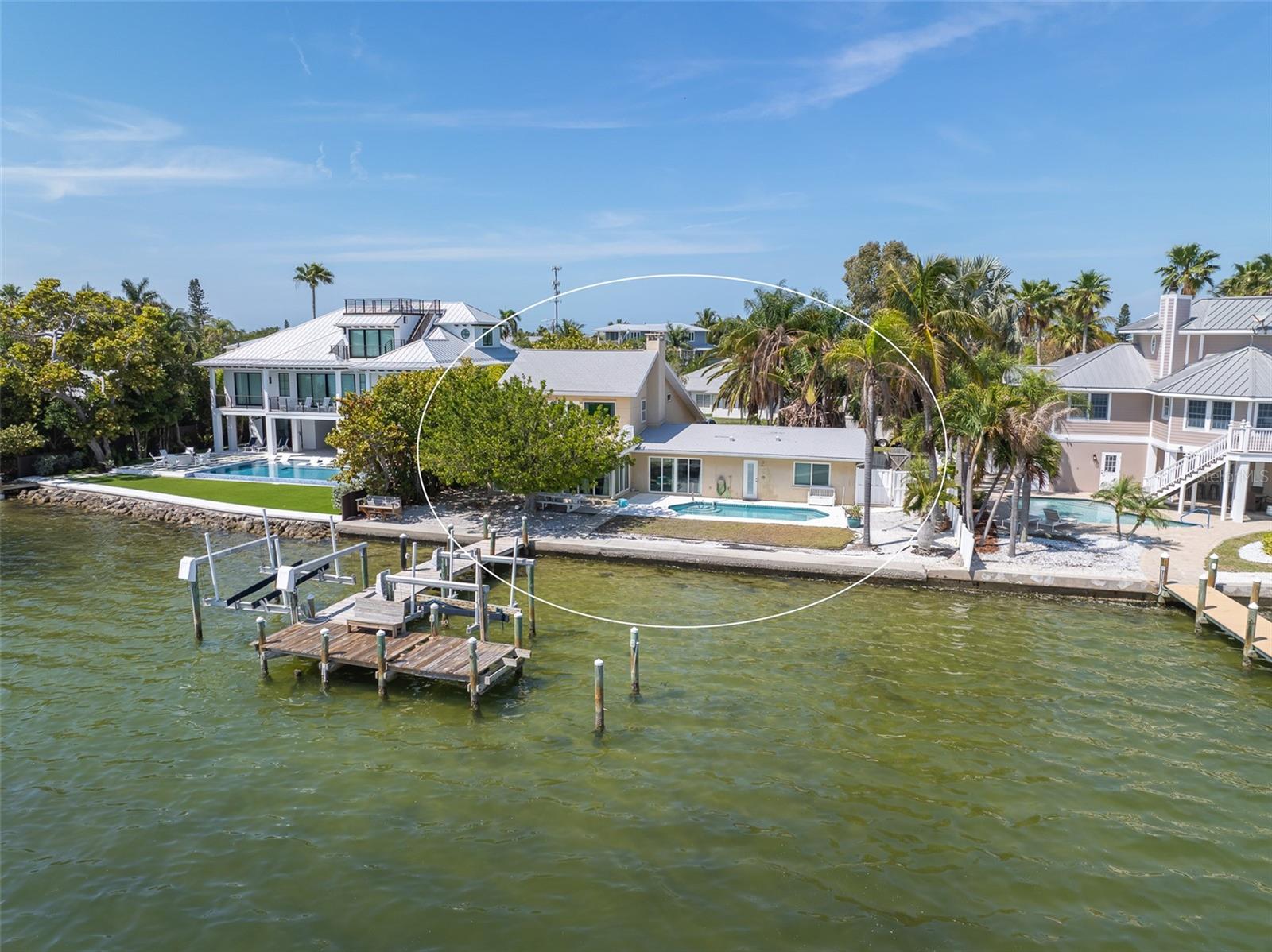 Great location WATERFRONT home centrally located in the heart of Holmes Beach on a quiet street on Anna Maria Island!! 90 feet of waterfront with gorgeous views!!! There is a home on the property, but selling for lot value only. Build your dream home and add your own finishes and personal style! Imagine waking up to the beautiful sunrise every morning! Nature is right in your backyard, watch dolphins jump around and manatees swimming by. These lots on deep water are hard to come by! Don't miss this rare opportunity with many possibilities with this property.