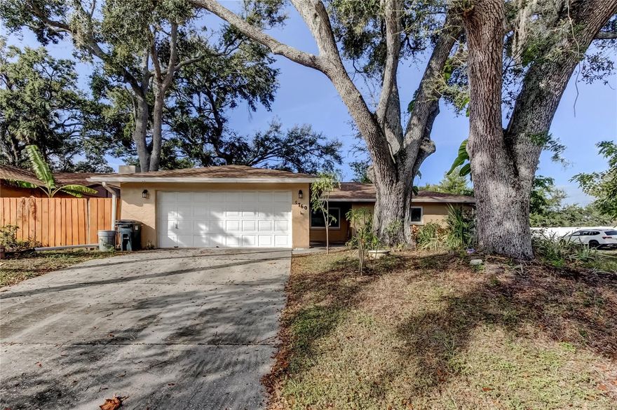 Under contract-accepting backup offers. Come check out this spacious home on a corner lot, nestled under the old oak trees. This home offers an open floor plan, (which includes the living, family, dining and kitchen area), along with 3 bedrooms, 2 baths, a bonus room, 2 car garage, screen patio and a fenced in yard. Exterior painting 2025, Shingle roof 2023, and new windows, between 2020 to 2022. This home would be perfect for a large family, or for those, who want a low maintenance yard, along with those who need extra parking for a boat or RV. Home is located within 15 to 20 minutes to the area beaches, and within 20 to 30 minutes to the St Pete Clearwater Airport and Tampa International Airport. Make this your new home today, before it's gone! All measurements are approximate.