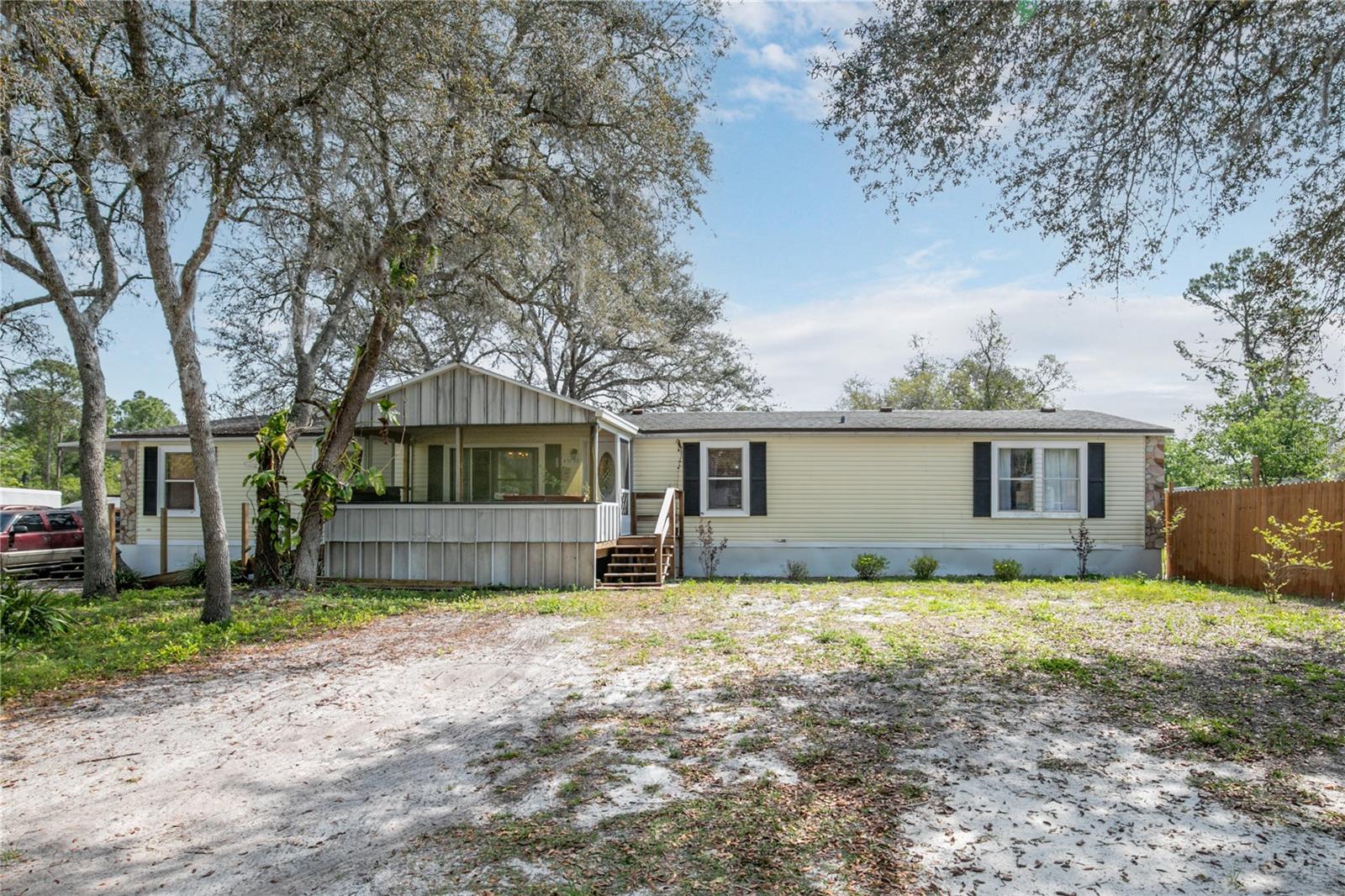 Are you looking for a large home, a large lot and a country setting, well you might have found it! This 2,300+- sq. ft. home on a half-acre lot is on a quiet road and has the majority of the property fenced in with a large gate. There's a detached garage and workshop; a front and back porch and it has a ramp to the front porch for easy access. The home has 3 bedrooms and 2 baths but there's a great room that can be converted into 2 more bedrooms. The Great room also has a wet bar with cabinets and a sink if you want to keep it as is for an entertainment area. It has a split floor plan, and the primary bedroom has a large ensuite with a garden tub and large walk-in shower. It has a large eat in kitchen which opens to the dining room and living room. If you need room both inside and out, then this is the property for you.