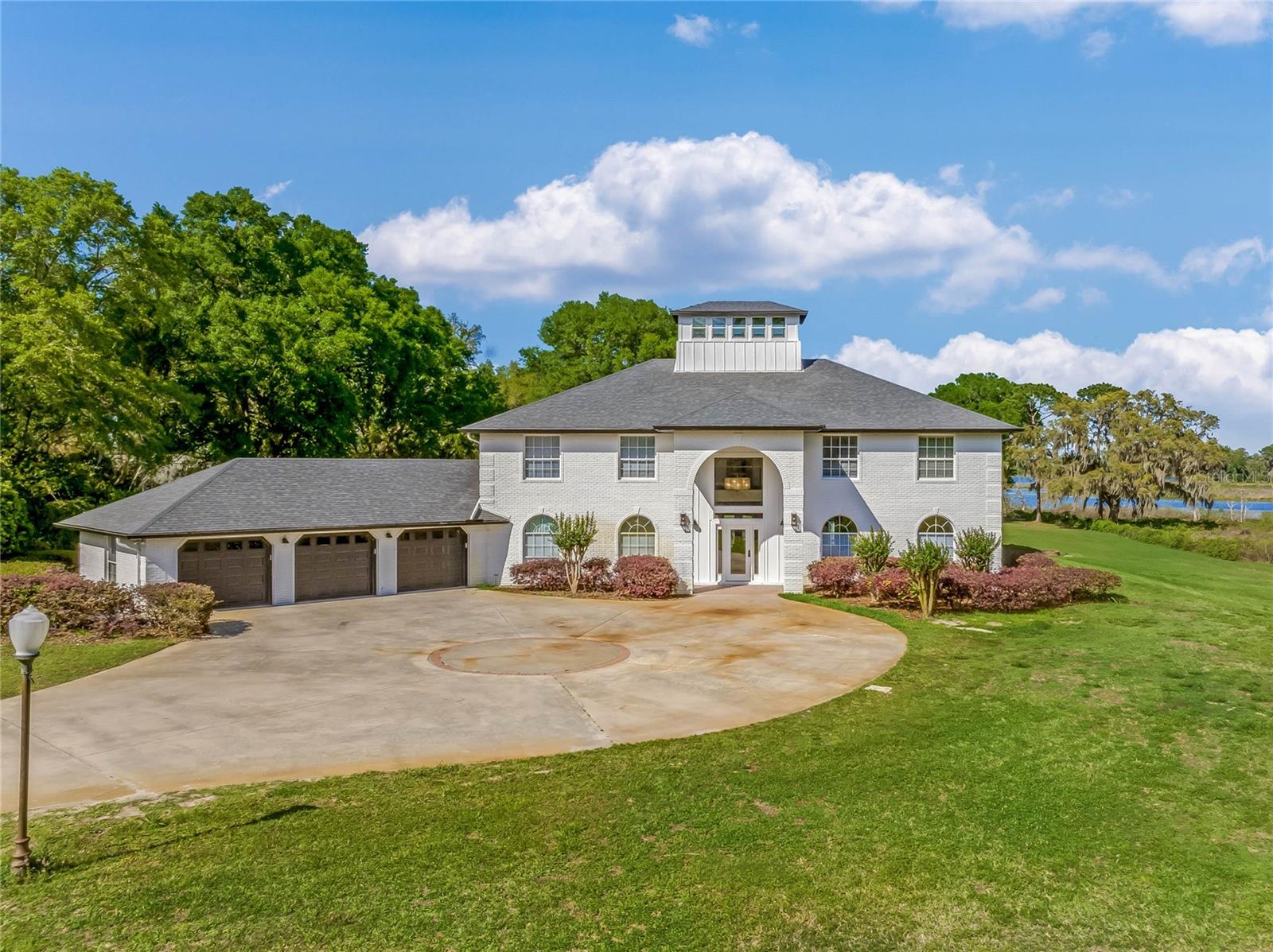 For anyone looking to enjoy Florida LAKEFRONT Living at its best, we present this noteworthy Estate home on 13.16 acres on Lake Daughharty. Stunningly remodeled and reinvented with no costs spared, the home boasts an open floor plan and 4 Master Suites and pool bath. The unique setting in Nature offers Privacy while being only minutes away from Shopping and Restaurants in Downtown Deland. The Gated driveway leads you through Majestic Oaks before opening up to panoramic views of the Lake. The home's entryway is a Show Stopper! The chandelier will draw your attention to the high ceilings while the modern floating staircase completes a sleek, modern farmhouse look. Architectural details such as the bookcase and Built Ins are complemented by natural light flooding the rooms. The entry level gives access to living, dining, kitchen - complete with Range, Granite Counters, Stainless Steel Appliances. The Master Suite, large office area and access to the Screened porch/Pool area with new travertine flooring. There are 2 Pantries, a large laundry room with sink and extra cabinets located downstairs. The 2nd floor offers a large Loft creating a perfect 2nd living area for 3 Master Suites. All Suites feature large closets and En-Suite bathrooms. Back downstairs 3 sets of French Doors lead to the screened Porch which adds 814sq ft of outdoor living space complete with 20X40 foot salt water pool, an outdoor kitchen including a fine wine fridge! The new 3 wide boat dock is a great spot for some early morning fishing in the Rain fed 293 acre Lake. You will be surrounded by the noises of nature and feel the peace as soon as you step on the Dock. In addition to the home's attached air-conditioned 3 car garage there is a detached 1,200 sqf workshop/4 car garage with large bay doors, lights and electrical service to store all your toys and create new work projects. Infrastructure designed with underground utilities and a 43 KW Diesel Standby Generator for peace of mind during Hurricane season. Other upgrades include a large and brand new water filtration system, real wood shutters, added large Cupola with cedar style hardie siding, added tongue and groove wood ceiling in pool area, new landscaping, new entry fence built out of 1" thick water contact treated Lumber and large 6x6 posts. The property is zoned AG and allows horses. This amazing property is one of a kind! Make your private appointment today!