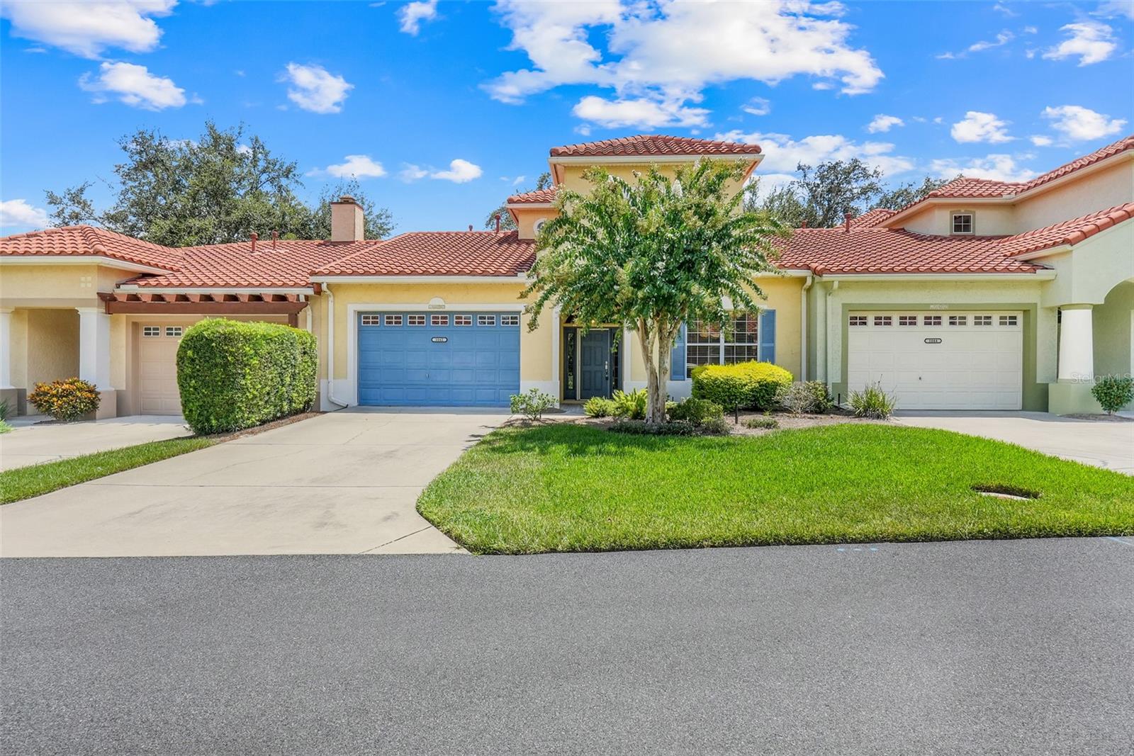 One or more photo(s) has been virtually staged. Welcome to this beautifully maintained 3-bedroom, 2.5-bath Vista Sonoma Villa, ideally located in a gated community just steps from the vibrant Spanish Springs Town Square in The Villages. This elegant home showcases a classic Spanish-style exterior with a California barrel clay tile roof, gutters, and downspouts—offering both charm and durability. A tiled front porch welcomes you into a bright and spacious foyer with soaring ceilings throughout. The FRESHLY PAINTED INTERIOR (2025) and beautifully REMODELED kitchen are true highlights. The kitchen features granite countertops, upgraded cabinetry, newer appliances, and a brand-new light fixture. It also includes a butler's pantry with plenty of cabinets for additional storage. The kitchen seamlessly flows into the living room, creating an ideal layout for entertaining. The living room includes a setup for a TV projector and opens through French doors to your private screened patio—perfect for morning coffee or evening relaxation. The main level hosts a generous primary suite complete with an en-suite bathroom and walk-in closet. Upstairs, you’ll find two additional bedrooms with BRAND-NEW carpet (2025) and a full bathroom with a shower-tub combo—perfect for guests or family, plus ample storage space. Additional highlights include an inside laundry room, a convenient half bath off the garage entry, and a 1.5-car garage with plenty of room for storage or a golf cart. Just a short walk from shopping, dining, and nightly entertainment, this immaculate villa offers the best of The Villages lifestyle. Whether you're entertaining or simply relaxing, this home is priced to sell and ready to welcome you home!
