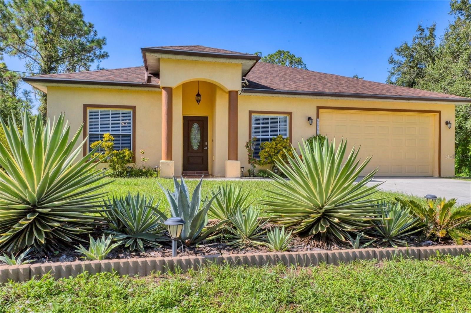 Incredible, Move-In Ready, this 3-bedroom, 2-bath North Port home blends Florida style with everyday comfort, no HOA or CDD fees! Step inside to a split-bedroom design for privacy and living space that flows seamlessly to a spacious, oversized screened lanai—perfect for year-round Paradise living. The primary suite is a true retreat, featuring dual walk-in closets and a spa-like bath with an oversized soaking tub, walk-in shower, and dual vanities. The kitchen shines with new appliances included induction range and range hood with external exhaust vent, Kitchen RO water filtration system, granite counters, bar seating and a pantry as well as Terracotta floor tiles with Talavera accents, while the separate dining and guest area adds charm and functionality. Outside, enjoy a peaceful, landscaped yard with mature fruit trees, dream garden and room to create your own outdoor entertaining space. A dedicated laundry room leads to a two-car garage with a Charger for an Electrical vehicle. Newer AC unit 2021as well as New Roof that was installed end of 2024. Prime location! Just minutes to I-75, US-41, Punta Gorda Airport, shopping, dining, and the Atlanta Braves Spring Training facility, plus a short drive to Gulf beaches, boating, fishing, and Warm Mineral Springs. This is your chance to own a slice of Florida paradise in a thriving community—don’t wait, schedule your showing today!