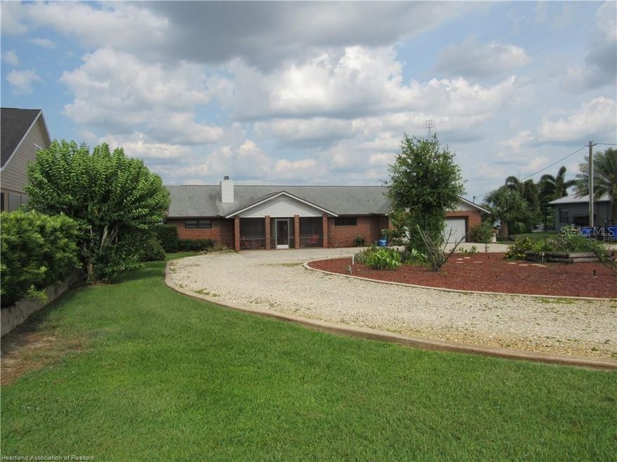 Lakefront Living at Its Finest! Welcome to 3955 Placid View Drive, a rare 1.1-acre lakefront retreat nestled on the shores of beautiful Lake Placid, one of Florida’s premier recreational lakes known for its clear water, excellent fishing, and stunning sunrise views. This spacious 3-bedroom, 3-bath home offers the perfect blend of comfort, function, and Florida lifestyle. The laundry/craft room could easily be converted into a fourth bedrooom. The open floor plan is ideal for both relaxed living and entertaining, and the bonus Florida room—complete with a cooktop and panoramic lake views—makes gatherings unforgettable. Hidden in the floor of the master walk in closet is a safe to keep your valuables secure. A full-house generator offers peace of mind, while the extra-large double wide garage provides ample space for vehicles, toys, or even a workshop. Enjoy morning coffee or evening breezes in the screened lanai overlooking the lake, or welcome guests from the screened front porch. The circular driveway makes access easy and adds a touch of grandeur to this private lakefront estate. Lake Placid, known as the "Town of Murals," is a charming small-town community rich in character and natural beauty. With over 27 freshwater lakes, the award-winning Caladium festival, and a friendly, laid-back vibe, it’s a hidden gem in Central Florida. Whether you’re into boating, fishing, golfing, or simply enjoying scenic views, Lake Placid offers something for everyone. This is more than a home—it’s a lifestyle. Come experience lakefront living on one of Florida’s most sought-after lakes. Call today to schedule your private tour of 3955 Placid View Dr! ***AN ESTATE SALE IS BEING HELD JUNE 6 & 7. PHOTO'S OF HOME WILL BE DISPLAYED AFTER ESTATE SALE***