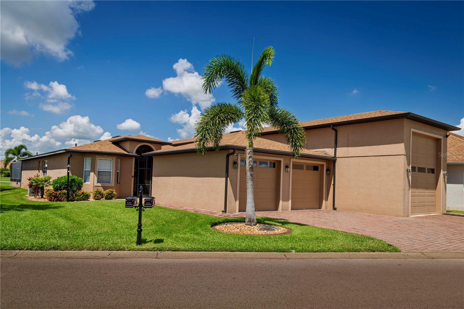Welcome to your personal haven and next chapter in beautiful Lake Ashton—Central Florida’s premier 55+ active-adult community, home to the LA Travelers, the largest Family Motor Coach Association chapter in the southeastern United States. Designed as both a luxurious retreat and a stunning travel base, this immaculate home radiates style, elegance, and Florida charm while offering unmatched versatility for the RV enthusiast, car collector, or boater with its massive, air-conditioned garage that accommodates four or more vehicles plus a 16’ by 48’ RV bay with full hookups. Inside, more than 2,300 square feet of custom living space unfolds with an inviting great room and kitchen crowned by a cypress wood cathedral ceiling. The chef’s kitchen boasts top-of-the-line appliances, cherry wood cabinetry with crown molding and refrigerator facings, granite counters, and a large island with electrical service. Just beyond, the den—currently used as a dining room—features pocket doors and could easily be converted to a third bedroom, while the primary suite is enhanced by a custom California closet. Off the great room, a spacious craft room with cabinets, counters, and a large island provides the perfect creative space, while an adjoining staircase leads to a well-appointed office with cabinetry and golf course views. Next to the carpeted stairs, a beautifully decorated 12’ by 15’ home theater conveys with all video and sound equipment, offering the ultimate entertainment experience. Additional living space flows to the enclosed, tile-floored, air-conditioned veranda. Beyond, the expansive, screened enclosure is ideal for entertaining, complete with a doggy grass area for pets. The air-conditioned RV garage includes a custom car lift and a second-floor 12’ by 15’ storage room, while the home itself is further secured with an electrically operated hurricane shutter at the front door. The roof was replaced in 2022. With extensive custom details too numerous to list, this residence perfectly balances tasteful luxury, comfort, and functionality, creating an exceptional environment for both lively gatherings and quiet retreats. Beyond the home, Lake Ashton elevates everyday living with two 18-hole championship golf courses, a 26,000-square-foot clubhouse, a state-of-the-art Health & Fitness Center, indoor and outdoor pools, pickleball courts, a bowling alley, theater, on-site restaurant, and a vibrant calendar of social events and clubs. Don’t miss the opportunity to call this warm, welcoming, and beautifully appointed home your own—schedule your private showing today and step into the Florida dream.