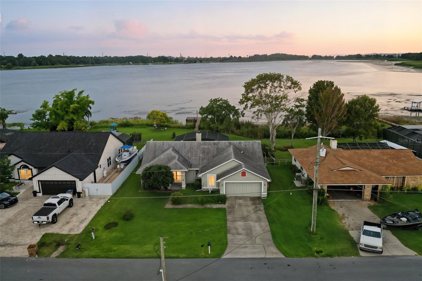 EXCEPTIONAL LAKEFRONT LIVING WITH PRIVATE DOCK, SCREENED POOL, SOLAR, NO HOA & NO FLOOD ZONE – A RARE FIND!
Discover the perfect blend of luxury, lifestyle, and location in this beautifully maintained lakefront home featuring your own private dock, a spacious screened-in pool, and stunning water views right from your backyard. Picture yourself ending each day with a breathtaking sunset over the lake, relaxing poolside, or gathering around the fire pit on crisp evenings—this home is your personal retreat for peace and connection.
Inside, you’ll find soaring ceilings, a bright open floor plan, and thoughtfully designed spaces that make everyday living a breeze. The versatile bonus 4th room—currently used as a dining area—can easily transform into a home office, media room, or extra bedroom to suit your needs.
Enjoy a fully fenced yard, solar panels for energy efficiency, a newer A/C system, and a prime location in a quiet, well-established neighborhood with NO HOA and NO FLOOD ZONE—giving you both peace of mind and freedom.
Homes like this don’t come around often—especially at this price point. Don’t miss your chance to live the lakefront lifestyle you’ve been dreaming of. Schedule your private showing today!