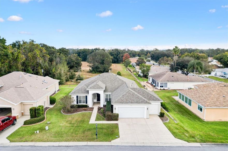 Welcome to this well-kept 3-bed, 2-bath home in the sought-after "Star Pass I" section of **Del Webb Spruce Creek Country Club**. If you’re dreaming of a peaceful Florida retirement with privacy and effortless living, this home checks all the boxes—**including no neighbors behind you**.

Inside, you’ll find an inviting open floor plan filled with natural light. Hardwood floors, comfortable living spaces, and thoughtful upgrades make the home feel warm and easy to enjoy. The kitchen is a highlight, with stainless steel appliances, stone countertops, a breakfast bar, an island with extra storage, and a pantry plus floor-to-ceiling cabinetry.

The primary suite offers a quiet place to unwind, featuring a walk-in closet, dual sinks, a private water closet, and a spacious walk-in shower. Two guest rooms and a second full bath make it simple for family or friends to visit.

The enclosed lanai is perfect for morning coffee, reading, or enjoying the Florida breeze without leaving the comfort of your home. You’ll also appreciate the interior laundry room, Ring Doorbell, and a **2-car + golf cart garage**—ideal for getting around this golf-friendly community.

Del Webb Spruce Creek offers an active 55+ lifestyle with four 9-hole golf courses, indoor and outdoor pools, pickleball, tennis, fitness center, walking trails, and 70+ clubs. On-site dining, including Liberty Grille, adds convenience, and you’re only minutes from The Villages.

A warm, comfortable home in a community designed for the lifestyle you’ve been looking forward to—come see it.

Easy access to restaurants, shopping and doctors. Schedule your appointment to see this home and start living your Retirement Dream!