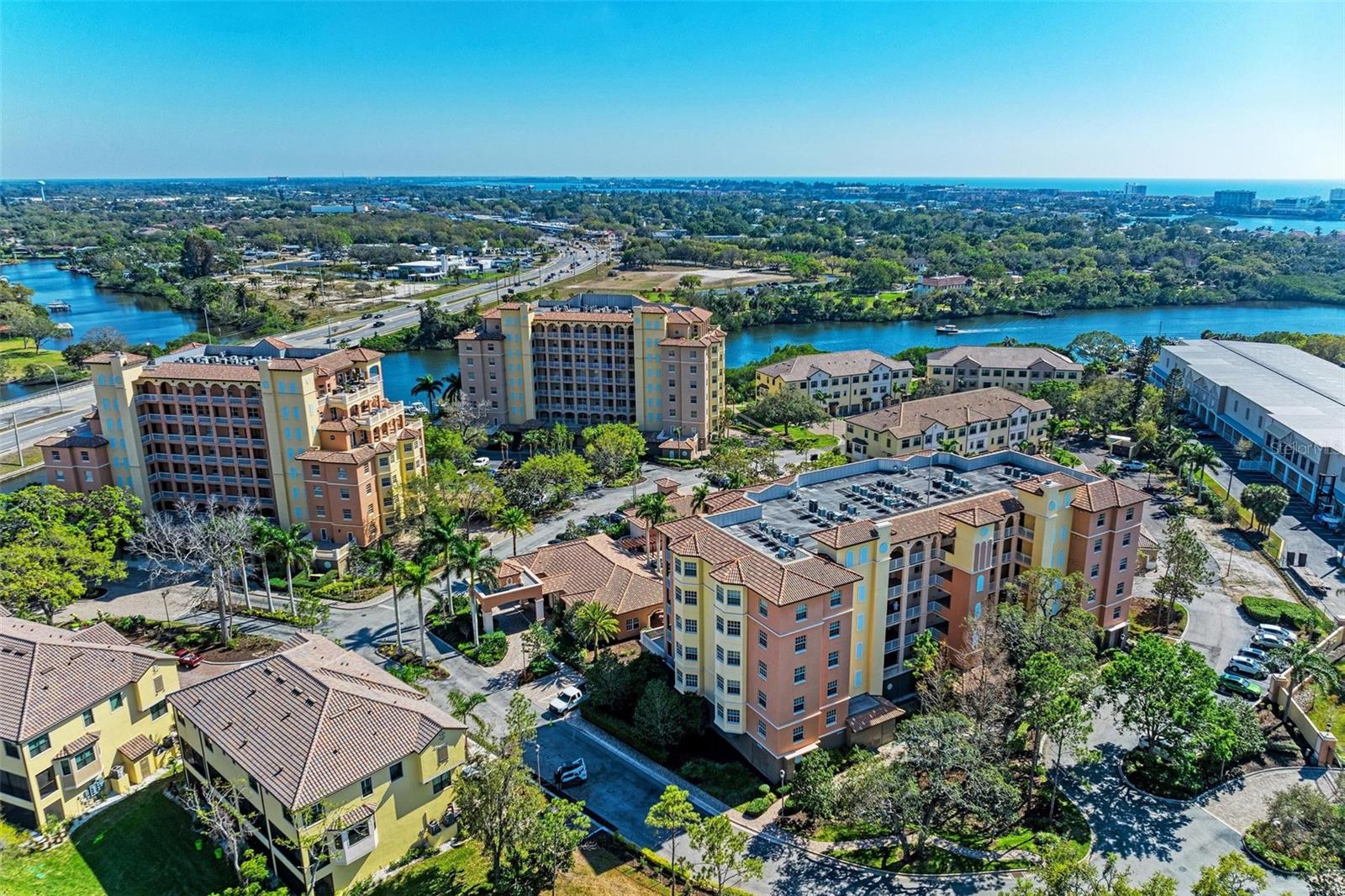 INDULGE IN COASTAL LUXURY!! You can live the coastal life with this "IMMACULATE & MOVE-IN READY" 2-bd/2-ba+study/den condo! All furniture, TV’s, & balcony furniture are included with the sale!! Phillippi Landings is a beautiful, gated waterfront community, across the ICW from Siesta Key. Siesta Key beach is less than 4 miles & only a 19 min bike ride or 10 min car ride. Another location highlight is the short trip to downtown Sarasota less than 15 mins away! Tastefully decorated, the condo features 10’ ceilings, solid core interior doors, an oversized extended balcony, & storm impact windows/sliders! A complete remodel was done to bring all elements of the design together for a subtle & minimalist lifestyle. As you enter the home, the entry foyer is accented by tray ceilings & perfectly paired designer lighting to create an elegant pathway into the open floor plan. You will notice this condo is very spacious throughout every room. The clean & stylish kitchen is one of the focal points of this home which has casual dining aside from the counter-height peninsula. The peninsula has been extended both wide & long to allow seating for 4, which makes it useful for entertaining or morning meals. The kitchen has everything that will invite any chef to create a delightful feast. Kitchen upgrades include soft close 42” solid wood cabinetry & designer hardware, Cambria quartz (LIFETIME warranty!) surface with a waterfall end, a supersized single-bowl sink, glass tile backsplash, slide-in double oven air fryer range, microwave, & a quiet garbage disposal & dishwasher. The kitchen has smart controlled/dimmable (switch, voice or app) LED flush ceiling lighting, sleek pendant lights, and color changing under cabinet lights. The floor plan offers solitude for the primary suite in the rear of the home with dual walk-in closets. The primary bath has a large walk-in shower, private water closet, comfort height vanities, & large freestanding tub. Upgrades in the owner’s bath include spa color lighting, frameless shower glass, soft close solid wood cabinetry w/quartz counters, shower bench, & modern bath fixtures—rainfall shower head & swivel tub spout along with a separate hand shower in both areas for ease of cleaning! The landscape orientation of the designer porcelain tile in the wet areas highlights the linear linen features of the tile. Narrow grout lines include sealer to minimize staining. The 2nd bedroom is nestled in the front of the home with the study/den just off the kitchen. The guest bath allows for En-suite privacy for the 2nd bedroom. The guest bath upgrades are like the primary bathroom other than the portrait orientation of the porcelain tile. Also, the shower has been extended. The flex/den/study can be converted to a bedroom with a daybed or remain an office. ALL flooring throughout the living area is upgraded with Tesoro LVP on a 45 degree angle & 6 1/2 inch wide baseboards. The upgrades on this home continue with designer lighting, ceiling fans, & smart lighting features throughout. All appliances convey--except wine fridge. Phillippi Landings is the perfectly located PET FRIENDLY community with some of the lowest fees within a 10 mile radius of downtown Sarasota for a Highrise condo this close to the beach. Amenities include cable tv, internet, water, sewer, & trash, kayak storage/launch & much more! You can purchase/lease a boat dock within the community (subject to availability) or at the Phillippi Harbor Club Marina next door.