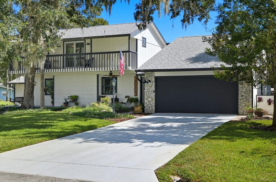 Welcome to this unique 2-story ranch in Florida Shores! This spacious home features an open-concept layout, beautifully updated eat-in kitchen with bar seating, and a stone wood-burning fireplace as the centerpiece of the living area. The upstairs retreat offers a large bedroom, full bath, and private balcony—perfect for guests or a peaceful getaway. With two separate garages, there’s plenty of room for vehicles, storage, or hobbies. Ceramic tile flooring runs throughout, and the enclosed backyard patio is ideal for relaxing or entertaining. Enjoy peace of mind with a newer roof. A rare find in the area, this well-designed home is move-in ready and waiting for you!