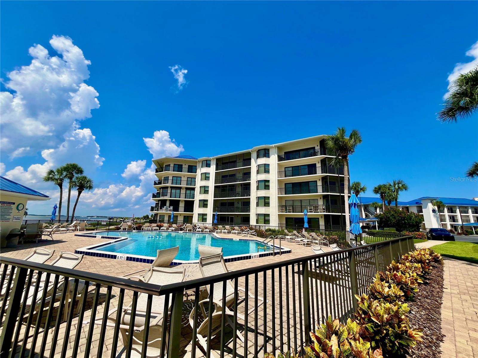 Fantastic opportunity to live on the Intracoastal waterway with Marina Views. This beautiful fully furnished Condo is located in the sought after gated condo association of Inlet Marina Villas. Enjoy the best of both worlds living on the intracoastal waterway with spectacular views of sunsets, frolicking dolphins, marina plus the beautiful yachts and boats passing by. The community offers direct access to the intracoastal waterway and access to the private beach walkway across the street. Enjoy the beautiful views of the Marina and Intracoastal waterway from your kitchen, living room, primary bedroom, one of the guest bedrooms plus your private screened 26 foot balcony!!! This tastefully decorated fully furnished, fully equipped home has 9 foot ceilings, spacious open floor plan with natural light, split bedrooms, laundry closet, assigned covered parking spot plus plenty of guest parking. Inlet Marina Villas is located at the north end of New Smyrna Beach and is a private resort style community. You will enjoy the community heated pool, marina and fishing pier with the most spectacular Intracoastal views of Ponce Inlet lighthouse, disappearing island and the coast guard station. Inlet Marina Villas amenities include a riverfront kitchen with gas grills, fire pit, tennis and pickle ball courts, clubhouse, and kayak storage, heated community pool, plus the Marina offers boat slips for rent. Inlet Marina Villas is located in the desirable area of North Beach nestled between multi million dollar homes and the the Coast Guard Station just a 5 minute walk to Smyrna Dunes Park with dog beach and 2 miles of boardwalk, famous Flagler Ave is just 2 miles away. Walk, Cycle or Golf Cart Ride to the bustling nightlife, restaurants and shopping on Flagler Avenue or Canal Street.