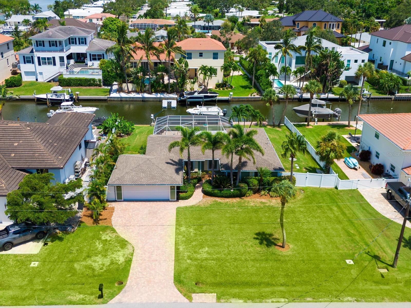 One or more photo(s) has been virtually staged. SARASOTA COUNTY - LOCATED NORTH OF THE STCKNEY POINT BRIDGE AND WEST OF THE TRAIL - AQUALANE ESTATES CHARMER - THIS NEWLY RENOVATED HOME IS LOCATED ON AQUALANE CANAL PROVIDING UNOBSTRUCTED DEEP- WATER ACCESS TO LITTLE SARASOTA BAY, ROBERTS BAY AND THE INTRACOASTAL WATERWAY WITH GULF ACCESS. AQUALANE ESTATES IS COMPRISED OF ONLY 4 DEAD END STREETS ALONG THE CANALS. PRIVATE DOCK WITH 10,000 LB LIFT, EQUIPPED WITH UTILITIES. POOL AND COVERED LANAI.
Lovely Florida home with vaulted ceilings. All new flooring, interior paint, new stainless kitchen appliances, kitchen cabinets and countertops, all bathrooms were also updated. On the outside, a beautiful landscape refresh. All windows and sliders are rated impact glass for your peace of mind and protection. Split floor plan offers a primary ensuite on one side and an additional private guest ensuite on the other side of the home. With 3 bedrooms you have great options for a
home office - library - craft room - nursery - or mother-in-law suite. This property provides that waterfront retreat you are looking for or maybe just use as a local weekend getaway for your boating pleasure. Enjoy the expansive views through the wall of sliding glass doors out to the screen covered lanai and inviting pool area - overlooking the canal.
This favorable neighborhood was developed in the early 1950's by Searcy Koen and is a popular choice for its location and features a variety of architectural styles from the beloved 60's ranch to luxury waterfront homes. Many buyers like to purchase these vintage homes to have a place in this quaint neighborhood for a new modern dream home one day! Close to downtown (5 miles) Siesta Key Beach (2.5 miles) Sarasota International Airport (10 miles). Sarasota Florida offers a blend of warm weather, beautiful beaches, world class fishing, and vibrant surroundings. This property shines and is move-in ready.