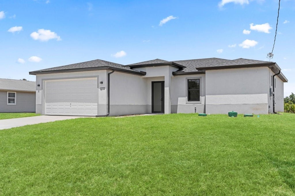 Photo of 2700 69th St W, Lehigh Acres, FL 33971 (MLS # C7530188)