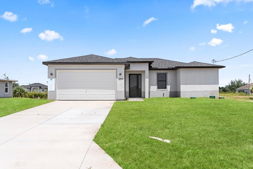 Photo of 2700 69th St W, Lehigh Acres, FL 33971 (MLS # C7530188)