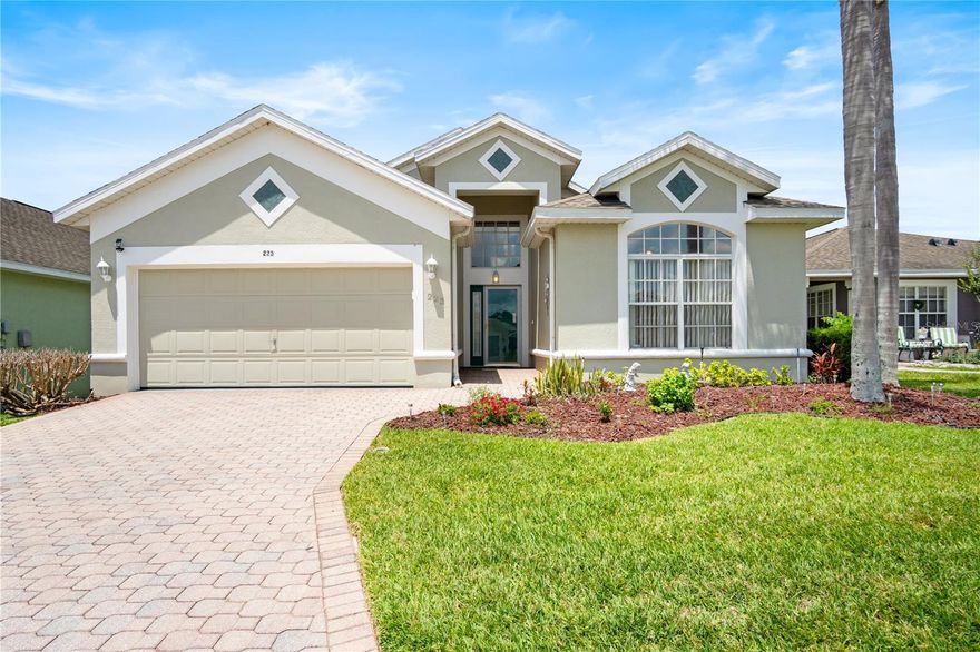 Beautifully maintained 2-bedroom, 2-bath Ridge Dale model with den located in the desirable 55+ gated community of High Vista at Ridgewood Lakes. This light and bright home features soaring 12-foot ceilings in the main living area, hardwood kitchen cabinetry, and a spacious primary suite with walk-in closet, garden tub, and separate shower.
Enjoy Florida living year-round from the oversized screened lanai with tile flooring and separate covered patio area. Mature tropical landscaping and palms provide added privacy.
Additional features include an expanded paver driveway and walkway, insulated garage door with Genie Pro opener, built-in garage storage and shelving, and pull-down attic access. Roof replaced in 2023, water heater 2023. Recent Four Point Inspection Report available. Home is being sold AS-IS. Furnishings available separately outside of contract.
HOA includes Spectrum basic cable service with two cable boxes, lawn maintenance, and access to the resident-owned clubhouse and amenities.
High Vista residents enjoy a heated pool and spa, fitness center, library, pub, tennis, pickleball, shuffleboard, bocce ball, walking and biking trails, and numerous community activities. Adjacent to the Ridgewood Lakes Golf & Country Club.
Conveniently located near shopping, dining, medical facilities, Orlando International Airport, Disney, Universal, and other Central Florida attractions. AdventHealth Heart of Florida Hospital is located just outside the community.