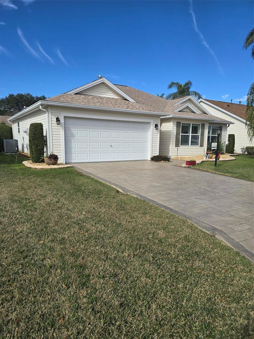 CHARMING 3/2 WHISPERING PINE DESIGNER in the VILLAGE OF PIEDMONT - convenient to Mulberry Grove shopping area and Nancy Lopez Country Club. LOVELY entrance with a stamped driveway and wonderful curb appeal with STACK ROCK walls, palms and shrubs. LAMINATE flooring (NO CARPET in this home) and CROWN MOLDING throughout. The spacious kitchen has HONEY OAK cabinets w/crown molding, hardware & pull-out drawers, GRANITE counter tops, TILE back splash, breakfast bar, large TILE flooring and a convenient casual dining area with lovely bay window. The updated STAINLESS appliances include a FRENCH DOOR refrigerator with bottom freezer, beautiful 5 burner GAS range, dishwasher and mounted microwave. The spacious living room has PLANTATION SHUTTERS covering the sliding glass doors that lead to your ENCLOSED lanai with TINTED  Windows and TILED flooring, a great place to sit and enjoy your morning coffee with privacy landscaping. A nice patio off the lanai is great for your grill. The master bedroom features a walk-in closet, vaulted ceiling, PLANTATION SHUTTERS and en-suite bath with GRANITE countertop w/DUAL SINKS and updated shower with FRAME-LESS GLASS DOORS. In the front of the home is your guest bedroom and guest bath with GRANITE countertop and tub/shower.  Double French doors open to the 3rd bedroom/den (no closet). A NEW ROOF was installed in October 2019; NEW HVAC 2017 and NEWER LG WASHER & DRYER! Other GREAT FEATURES: vaulted ceilings, décor colors, CROWN MOLDING THROUGHOUT, PLANTATION SHUTTERS on the windows and sliding glass doors, NO BOND and more!!. Great location to shopping, restaurants, pools and golf courses … all the amenities of The Villages!  GOLF CART is Negotiable.