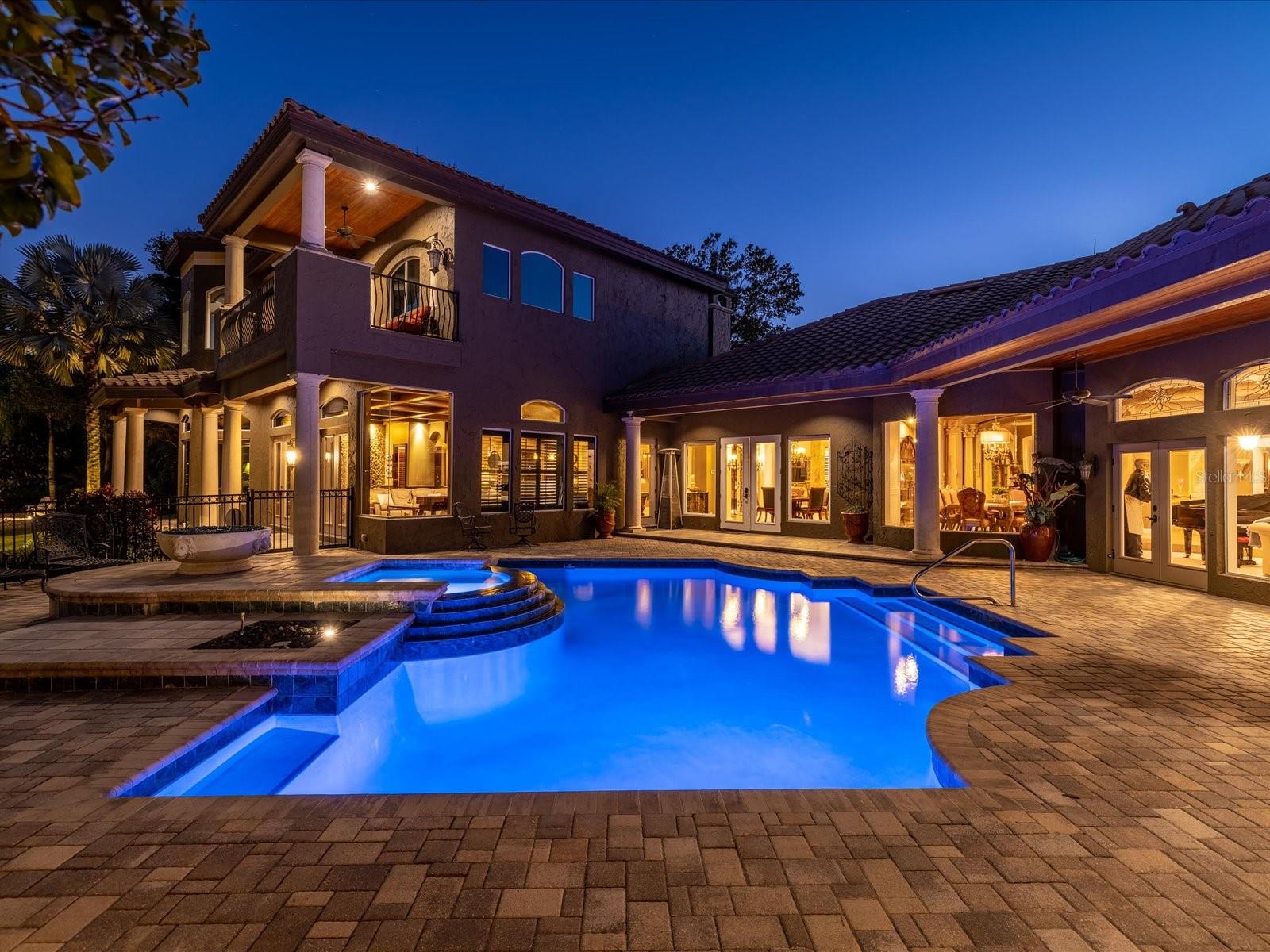 Beyond the gates of the coveted Lakes of Keystone community, nestled on a little over an acre of lush landscaping and serene lakefront, 17816 Willow Lake Dr. welcomes you home. Masterfully designed with an eye towards quality and classic style, this estate boasts more than 9,200 square feet of living space that includes 5 bedrooms, 5 full bathrooms, 2 half bathrooms, and a 5-car garage. This luxurious estate, originally constructed in 1993, underwent a transformation in 2008 with the addition of a sprawling two-story expansion. The first-floor enhancement boasts a massive entertainment/living space, an full service indoor bar, a generously-sized fourth bedroom & full bathroom for guests or family, a temperature controlled wine cellar to preserve your finest vintages, and an attached two-car garage featuring an expansive, air-conditioned storage room complete with washer and dryer hookups. Ascending to the second floor, you'll discover a perfected ten person soundproof home theater, ensuring cinematic experiences beyond compare. Adjacent, a bonus room adorned with a wet bar and an inviting outdoor balcony offer unparalleled entertainment options. The fifth bedroom suite, ingeniously repurposed as a private gym retreat, comes complete with a full bathroom, steam shower, two person sauna, and a dedicated wet bar for post-workout relaxation. Designed with a chef in mind, the gourmet kitchen features a Sub-Zero refrigerator, Thermador dishwashers, Wolf gas stove and wall ovens, and an under-counter wine chiller. These top-of- the-line appliances are surrounded by beautiful solid wood cabinets, granite counters, and an oversized center island. In the well-appointed owner’s suite, you’ll find a relaxing and quiet space that includes a morning bar, adjoining office space, and ensuite bath with a stone shower, whirlpool tub, and dual walk-in closets. Enjoy your private outdoor oasis with a sparkling pool and spa complete with fire feature, full summer kitchen, extensive seating and dining options, and relaxing water features like fountains and Koi ponds with waterfalls. A short stroll down towards the lake will bring you to the private dock, shell beach, and gas fire pit with seating. Every upgrade and detail has been thoughtfully chosen to highlight the quality found throughout, from the timeless travertine and hand-scraped Maple flooring to the 8ft solid wood doors. Additional benefits such as a whole-house speaker and security system and pre-wiring for a generator will provide the new owner of this home an ideal combination of luxury and comfortable living. Call to schedule your private showing.