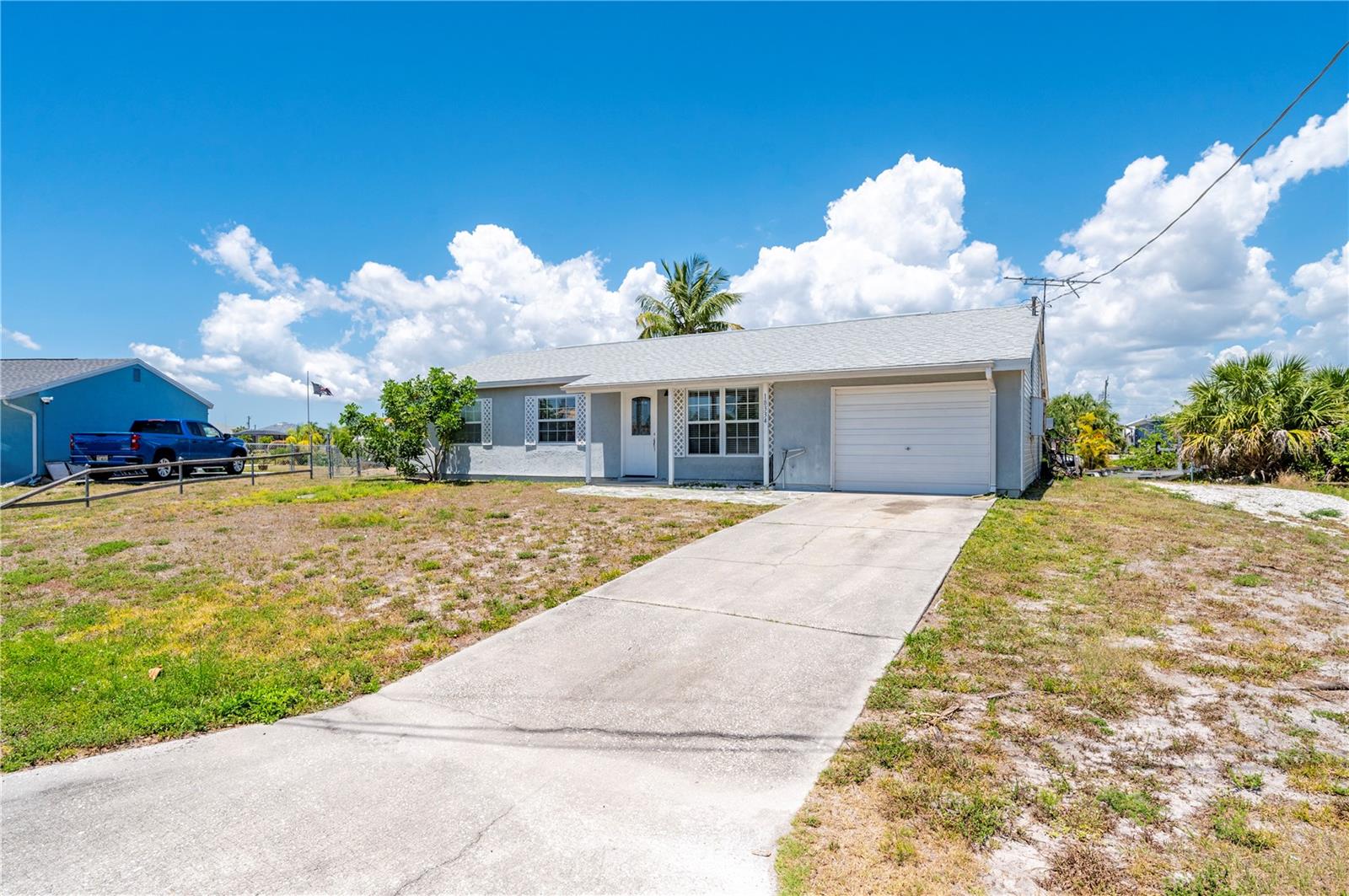 Welcome to your slice of waterfront paradise in Port Charlotte! This charming home boasts 118 feet of waterfront bliss, complete with a 40-foot composite dock and boat lift, making it a boater's dream come true. Say goodbye to those fixed bridges as you enjoy easy access to open waters via the saltwater canal right from your backyard. You'll love the peace of mind provided by the new roof installed in 2022. Step inside to discover a spacious interior featuring a delightful mix of tile and laminate flooring throughout. Need a space to work or unwind? The bonus room is perfect for a den or home office set up. The kitchen is a chef's delight with tile countertops, custom wood cabinets, and crown molding adding a touch of elegance. The primary bathroom boasts a walk-in shower for a touch of convenience. Outside, enjoy your own private boat ramp and riprap along with an oversized lot offering plenty of room for outdoor activities. This home comes furnished Turn key, so you can start off right away. Located just minutes from local amenities and downtown Punta Gorda, this property offers the best of both worlds – a serene retreat with easy access to the vibrant coastal lifestyle. Whether you're into fishing, boating, or simply soaking up the sun, this is the ultimate haven for your waterfront dreams.