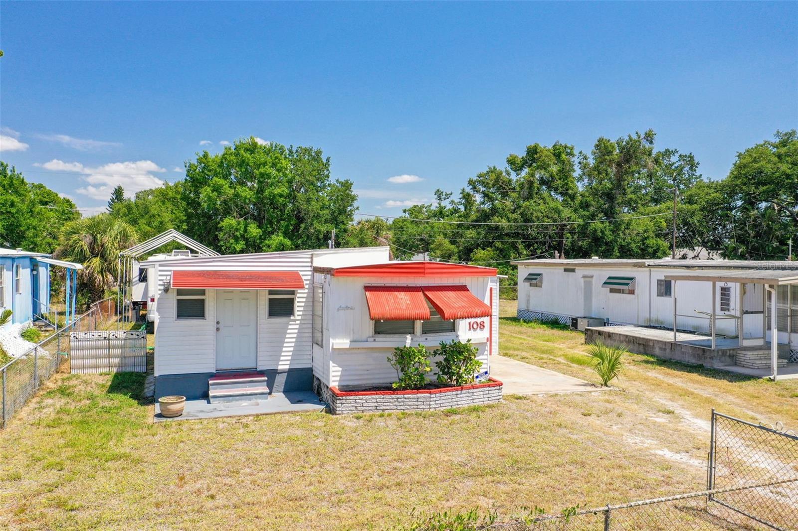 Located in the heart of coastal Nokomis, this 2 bedroom, 1 bathroom single-wide mobile home presents a rare chance to secure a property with strong investment potential in one of Southwest Florida’s most desirable areas. Just minutes from Venice Beach, Sharky's on the Pier, and Historic Downtown Venice, this property offers an ideal setting for a seasonal retreat, rental income, or future redevelopment. The current structure has been maintained and features a functional layout with an extended living area, a kitchen with a convenient breakfast bar, and a hallway that leads to two bedrooms and a full bathroom. The enclosed carport has been transformed into a garage with a dedicated laundry and storage area, offering added flexibility for use or conversion. The lot itself provides plenty of room for outdoor enjoyment or expansion, with no association fees or deed restrictions. Whether you choose to renovate, rebuild, or rent, this property offers the freedom to create value your way. There is also an RV on site that is available for separate purchase, offering additional flexibility for use or future rental income. This location is ideal for those who want to enjoy the charm and convenience of the Gulf Coast lifestyle. You’re a short drive to Venice Beach and the lively Historic Downtown Venice filled with dining, boutique shopping, farmers markets, and cultural events. Wellen Park and CoolToday Park are also nearby, offering year-round activities, spring training baseball, and new shopping and waterfront dining destinations. Additionally, adjacent Lot 110 (MLS #A4649828) is available for separate purchase or can be bundled as a packaged deal. This offers a unique opportunity to expand your investment footprint, live in one and rent the other, or build two income-producing properties just moments from the coast.