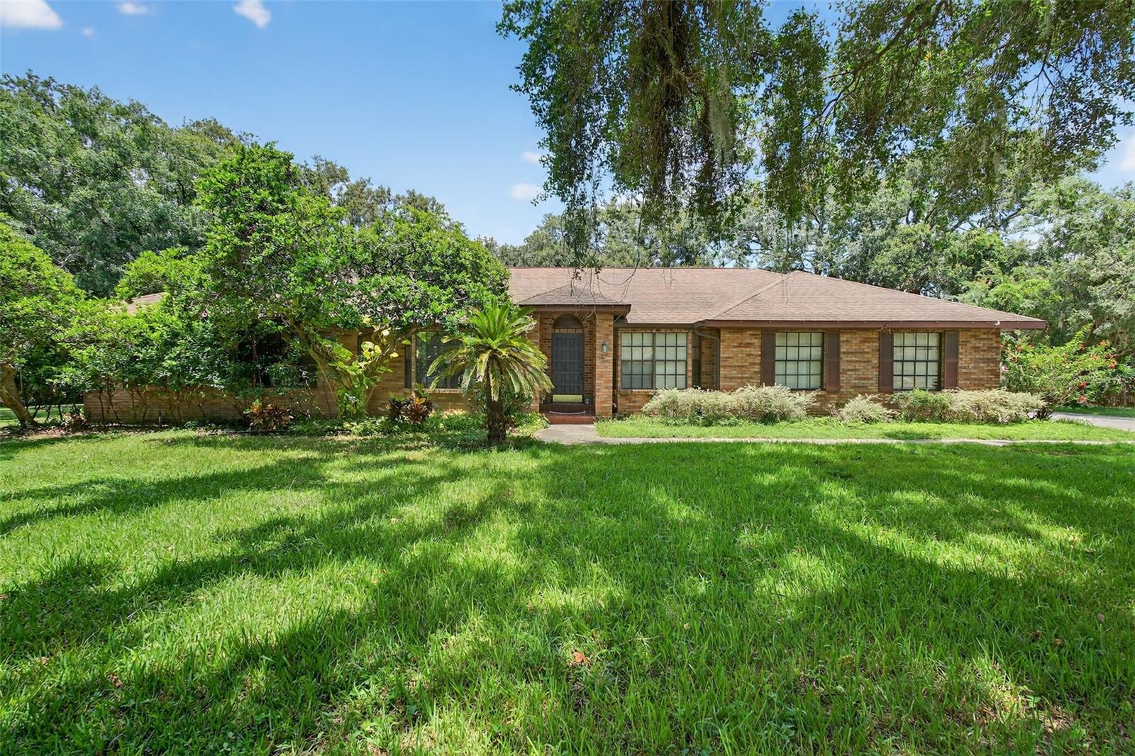 Discover space and character in this beautiful 4-bedroom, 3-bathroom home nestled on a large lot at the end of a quiet cul-de-sac in Dover. With over 2,200 sq ft of living space, this home offers an inviting layout perfect for everyday living and entertaining. Step inside to find vaulted ceilings, wood-look laminate flooring throughout, and a spacious family room with a cozy fireplace. The open-concept kitchen features granite countertops, stainless steel appliances, a separate pantry, and a breakfast nook, all flowing seamlessly into the family room. A formal dining room and front living room off the foyer add flexibility and charm. The split floor plan provides privacy, with a generously sized primary bedroom featuring a private en suite bathroom. Additional bedrooms are comfortably sized and share a full bathroom with a double sink vanity. Step out to the screened-in lanai, ideal for outdoor dining, and enjoy the expansive backyard - perfect for grilling, gardening, or simply relaxing in the Florida sunshine. Conveniently located near dining options, shopping centers, and zoned schools, this home offers the perfect blend of comfort, space, and location. Don't miss your opportunity to own this unique home full of charm and potential - schedule your showing today!