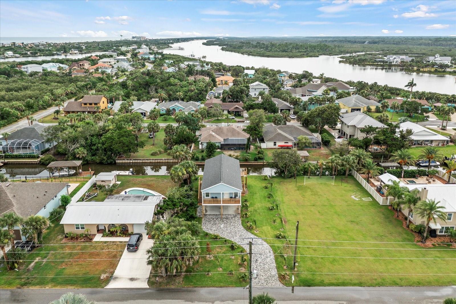 BOATER'S DREAM! Enjoy the ultimate Flagler Beachside, watersport and fishing enthusiast’s retreat. This bright, fully furnished stilt home on a saltwater canal just a short float away from the Intracoastal Waterway. Launch a boat or canoe right from the backyard from your private floating dock and be sure to bring your fishing gear for some of the best fishing Florida has to offer on the Intracoastal Waterway. Gamble Rogers Memorial State Park is just minutes away by boat. The Ocean just 5 blocks east for a quick bike ride or leisurely walk down the street to A1A. The famous cinnamon coquina sands of Flagler Beach are yours to enjoy in this quiet Florida Beach town which also offers trails, parks, water activities and dozens of unique eateries and shops just a short bike or golf cart ride away. Flagler Beach's down to earth, friendly community vibe makes it an ideal location for those who yearn for a relaxing, laid back, Old Florida beach town lifestyle. Need a little excitement? World famous Daytona Beach is just 30 minutes south, and historic St. Augustine is 30 minutes north. The attractions in Orlando are just 90 minutes away. This 3-bedroom, 2-bathroom stilt home offers upper-level living accessed by 2 staircases. Enjoy the canal view from the upper-level deck complete with outdoor furnishings accessed through the sliders from the living area. This home sleeps 8 comfortably. The Master Bedroom is complete with a king size bed and en-suite bath with a deck overlooking the beautifully landscaped yard with paver driveway. The 2nd guest room has a Queen bed, and the 3rd bedroom is outfitted with bunk beds to sleep 4. Bring your boat, kayaks, fishing gear, bicycles and vehicles – it will all fit neatly under the residence, offering covered storage for all the toys and an outdoor shower to rinse off the sand. Located on a secluded street in the midst of all Flagler Beach and the Intracoastal Waterway has to offer, this home is fully furnished, including cookware, dishes and glassware. All furnishings are new, high quality throughout. Full size washer and dryer are tucked away conveniently in the hallway closet. Rent includes lawn maintenance, water and trash removal. Absolutely NO SMOKING indoors, outdoors or anywhere on the property. We love animals but due to allergy concerns absolutely NO pets or animals indoors or outdoors or anywhere on the property. This is a NO PET rental. The home is located on a quiet, safe and secluded street. Guests must also be quiet and respectful. Come and plan an extended vacation or make it yours for a long-term lease at this home in Flagler Beach, Florida’s East Coast's best-kept secret.